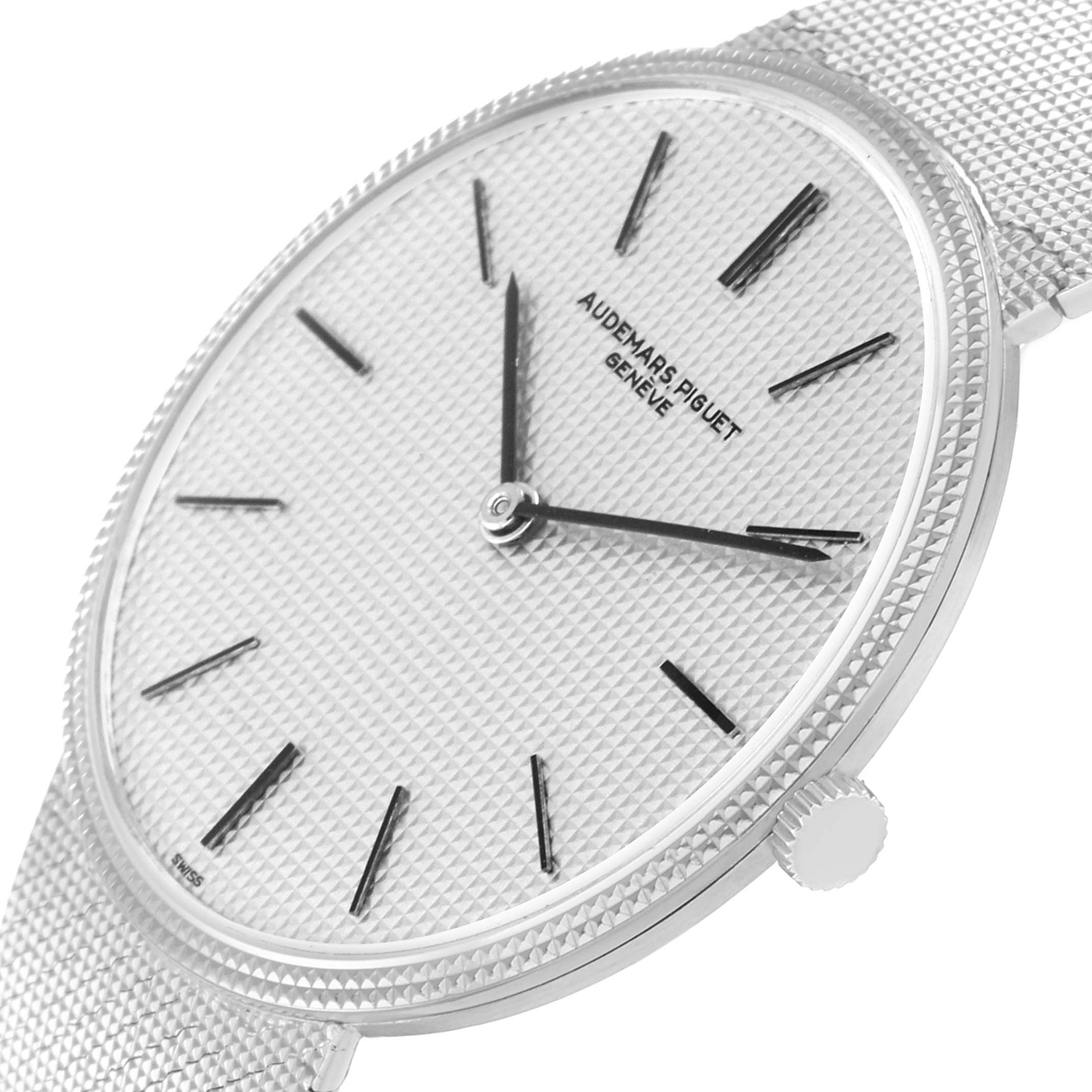 The Audemars Piguet Vintage Men
s White Gold Silver Dial watch is shown at an angle highlighting the dial, crown, and textured bracelet.