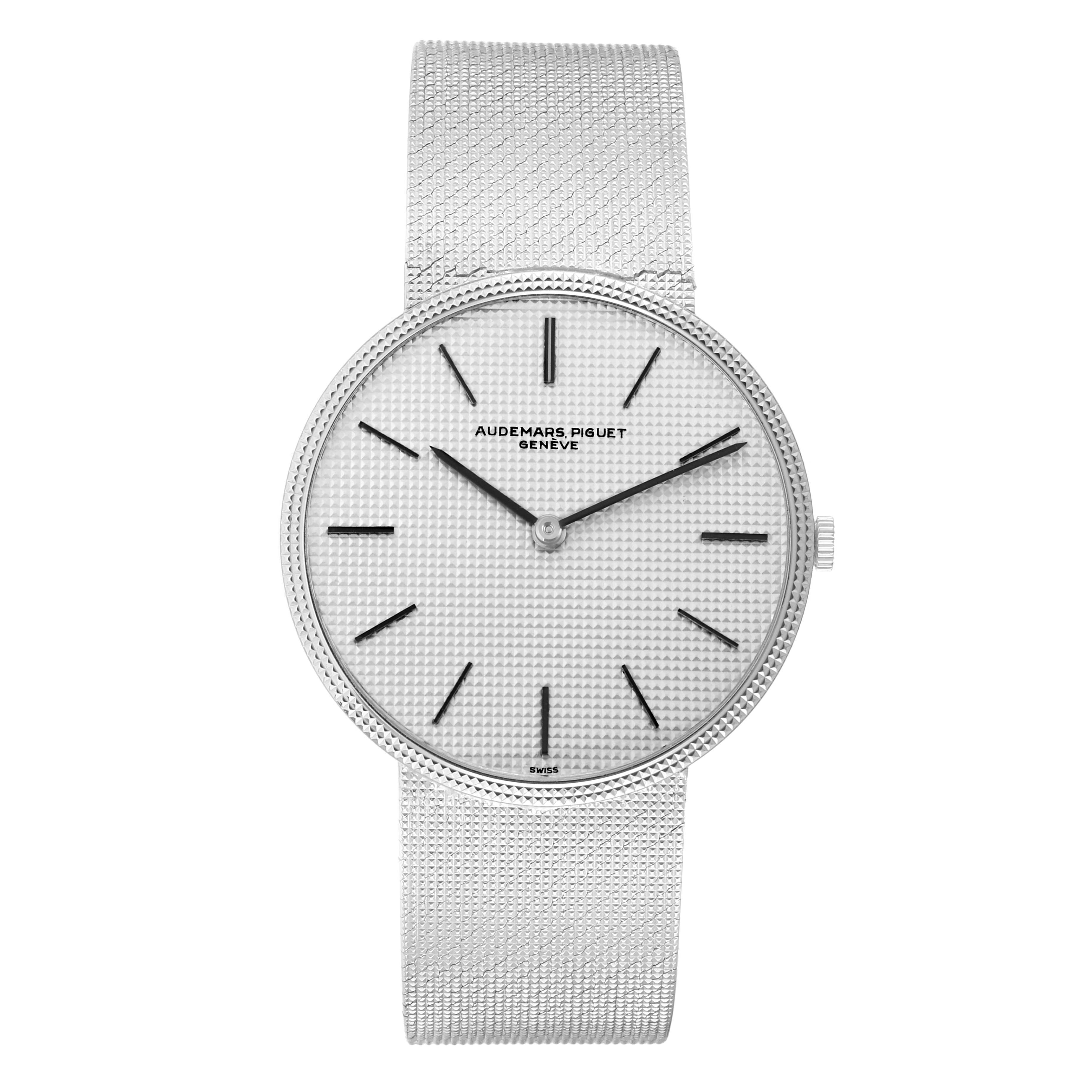 The Audemars Piguet Vintage Men
s White Gold Silver Dial model is shown from a front angle, displaying its textured dial and mesh bracelet.