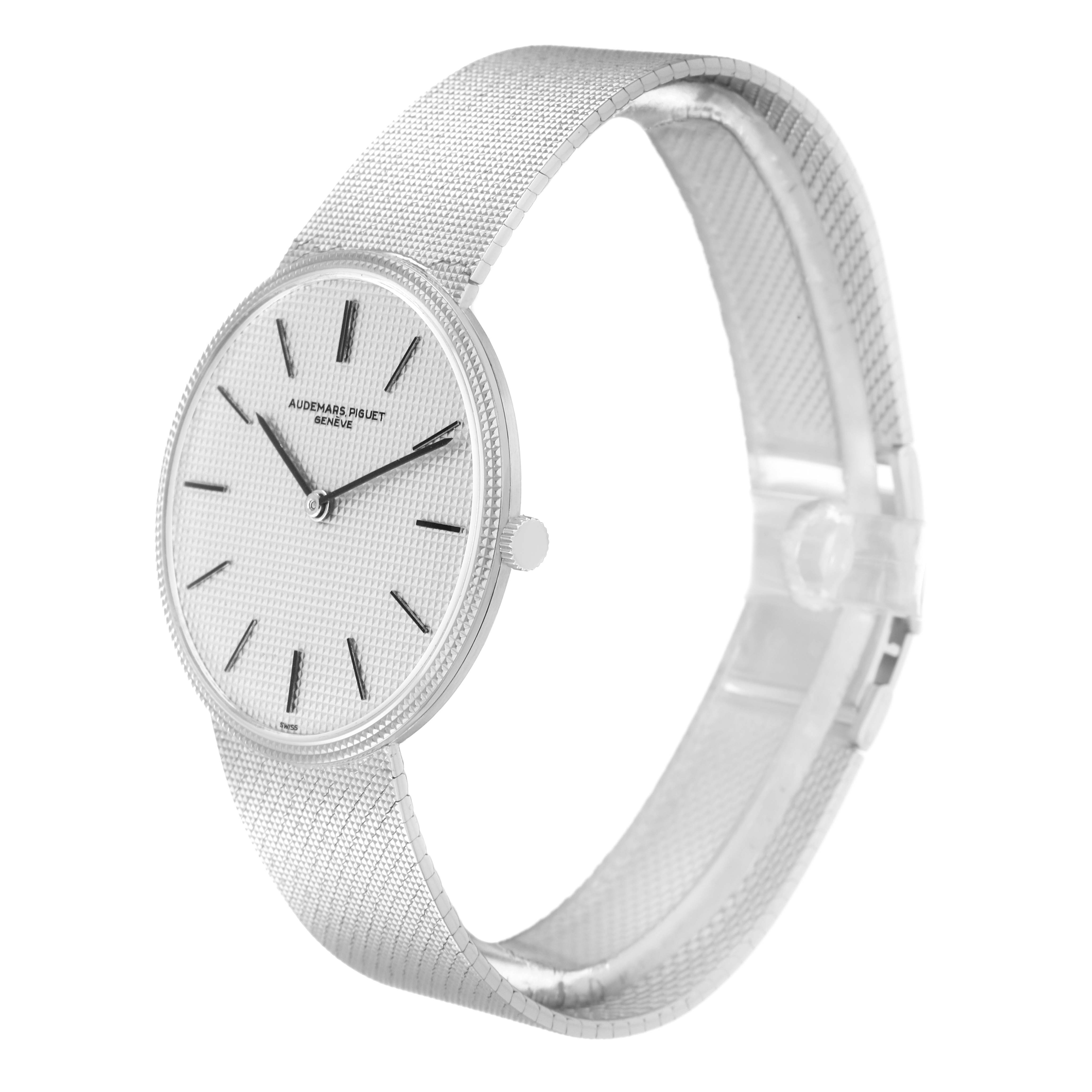 The Audemars Piguet Vintage Men
s White Gold Silver Dial watch is shown at a three-quarter angle, highlighting the textured dial and mesh bracelet.