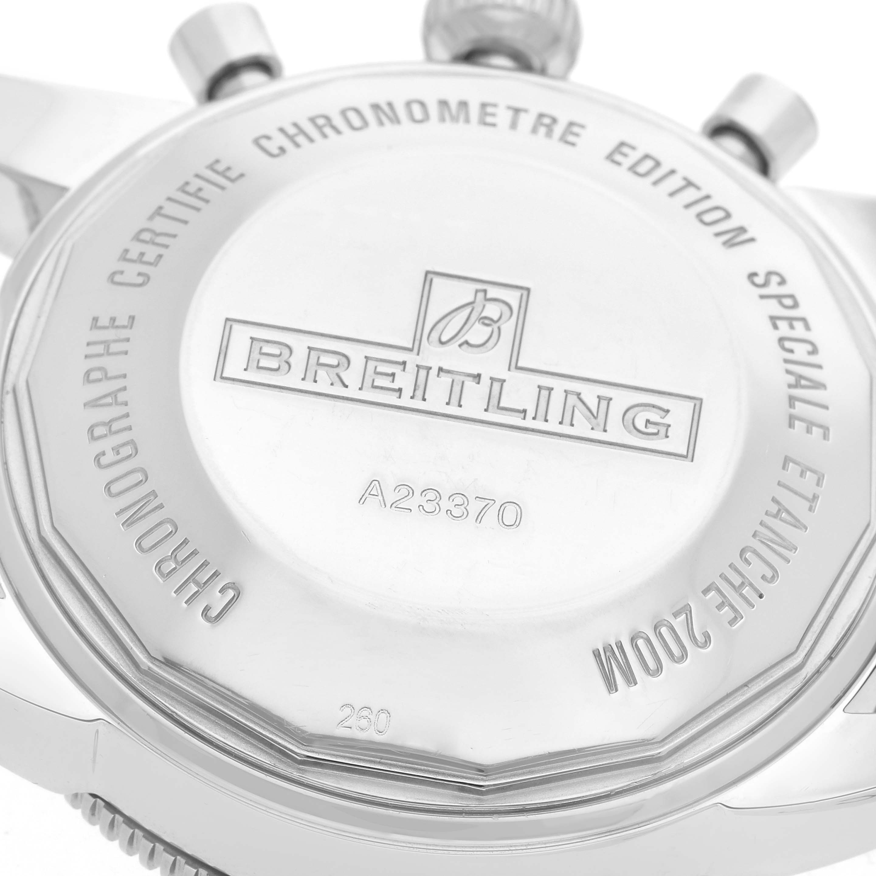 The image shows the case back of the Breitling Superocean A23370 Men
s Stainless Steel Black Dial watch at a close-up angle, highlighting engraved details and the brand logo.