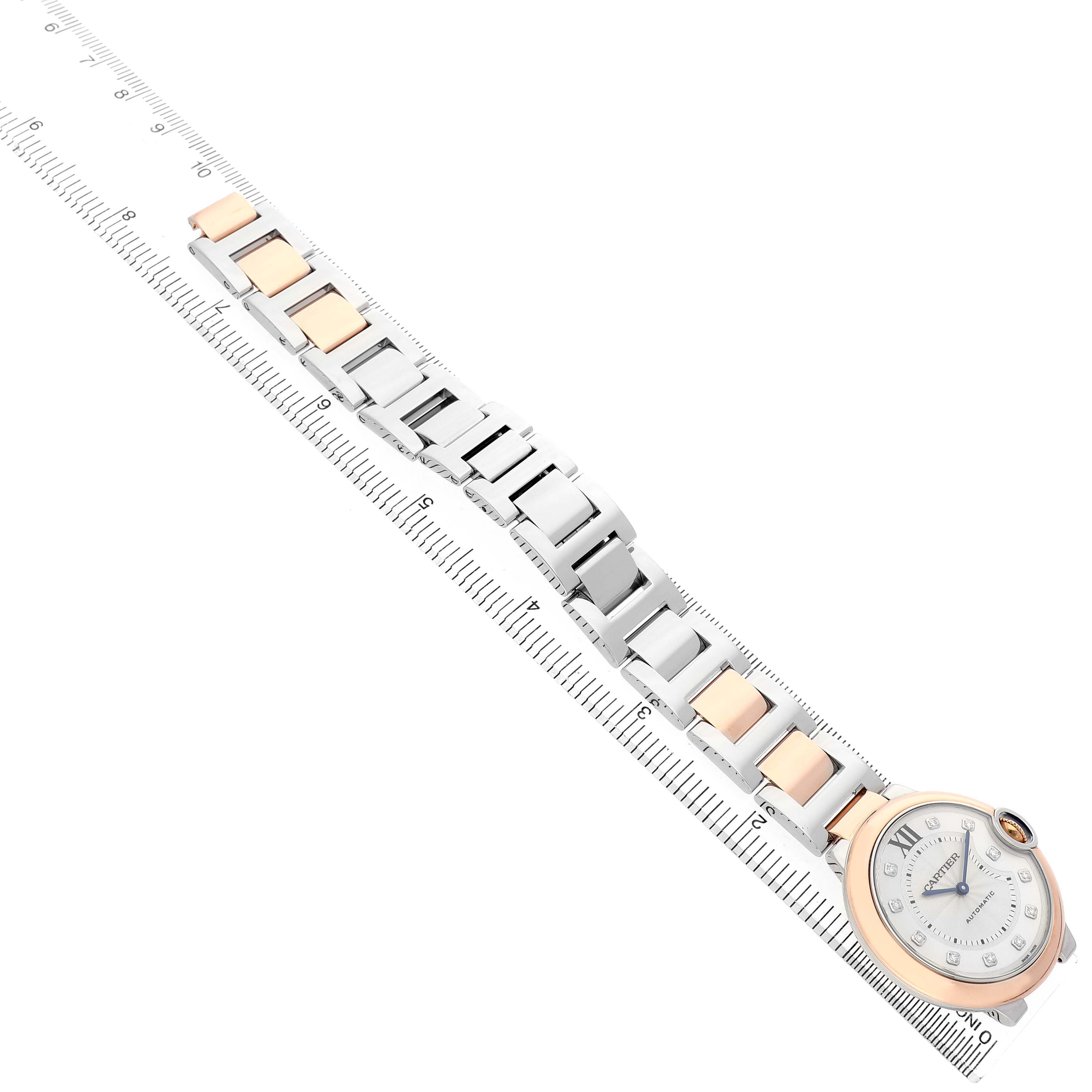 The Cartier Ballon Bleu W3BB0013 Men's Steel and Gold (two tone) Silver Dial watch is pictured flat, showing the face, two-tone bracelet, and ruler for scale.