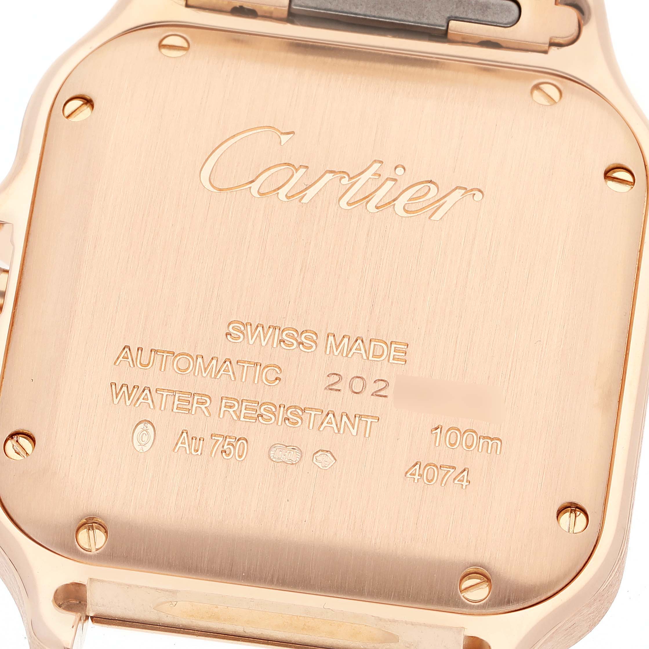This image shows the case back of a Cartier Santos WGSA0008 Men's Rose Gold Silver Dial WGSA0008 Men's Rose Gold Silver Dial watch, highlighting its engravings and screws.