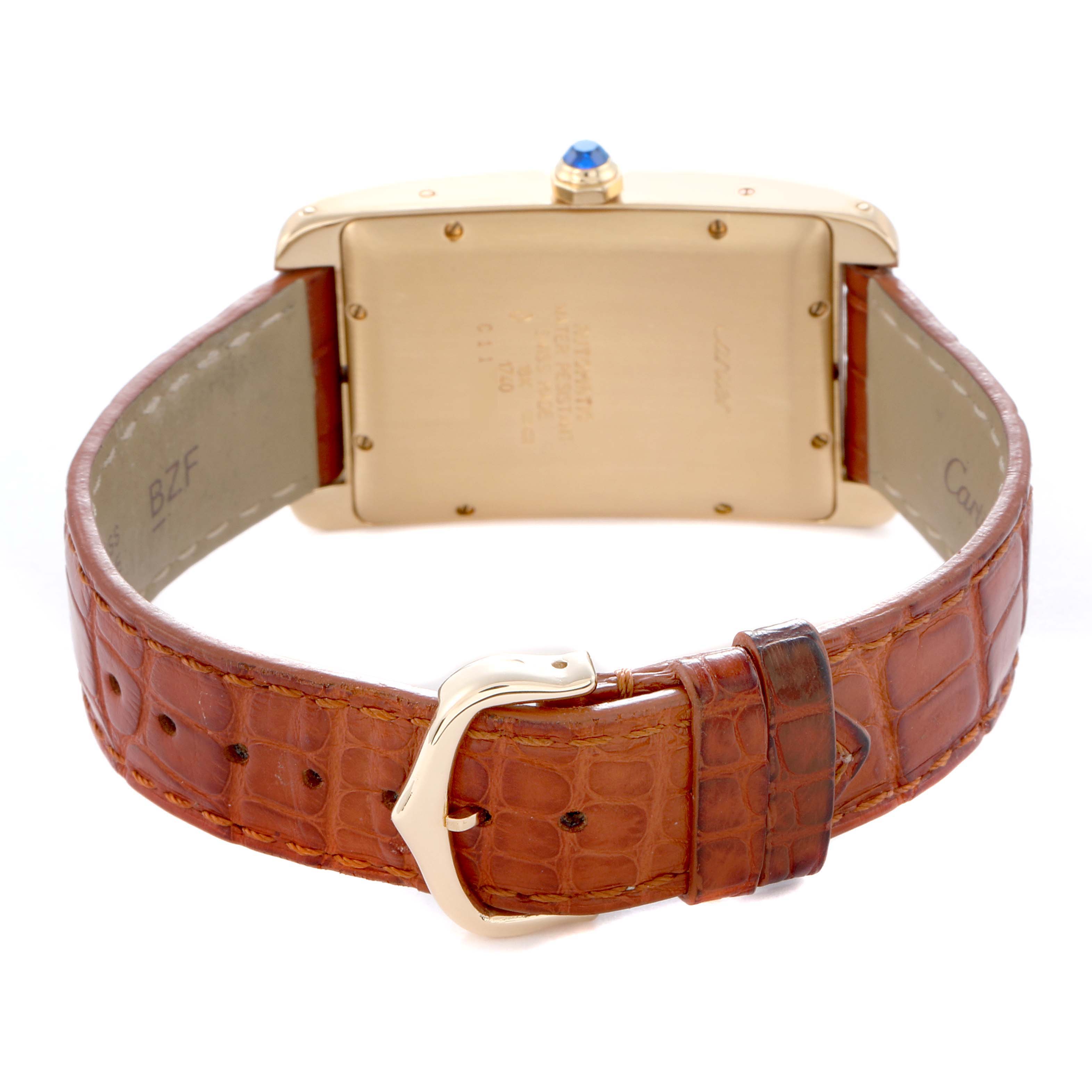 The image shows the back of the Cartier Tank Americaine W2603156 Men
s Yellow Gold Silver Dial watch, highlighting its case back, buckle, and leather strap.