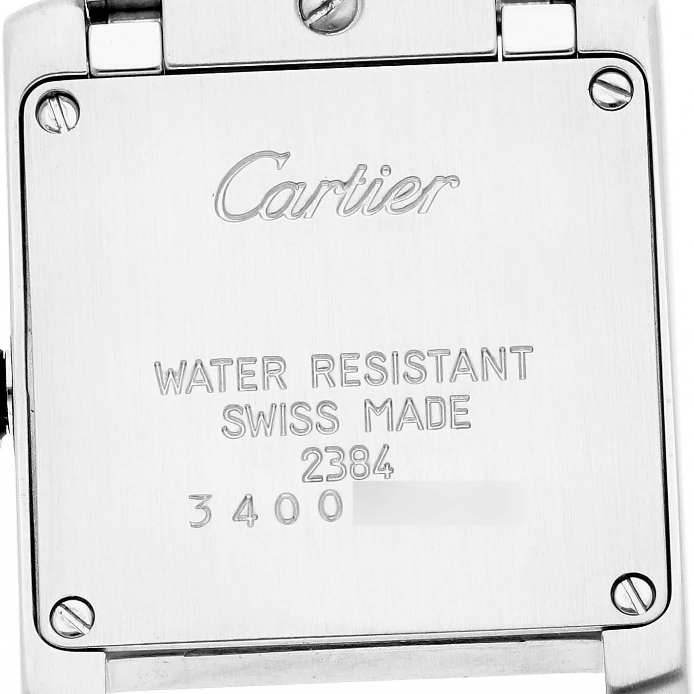 The image shows the back case of a Cartier Tank Française watch, featuring engraved details and screws.