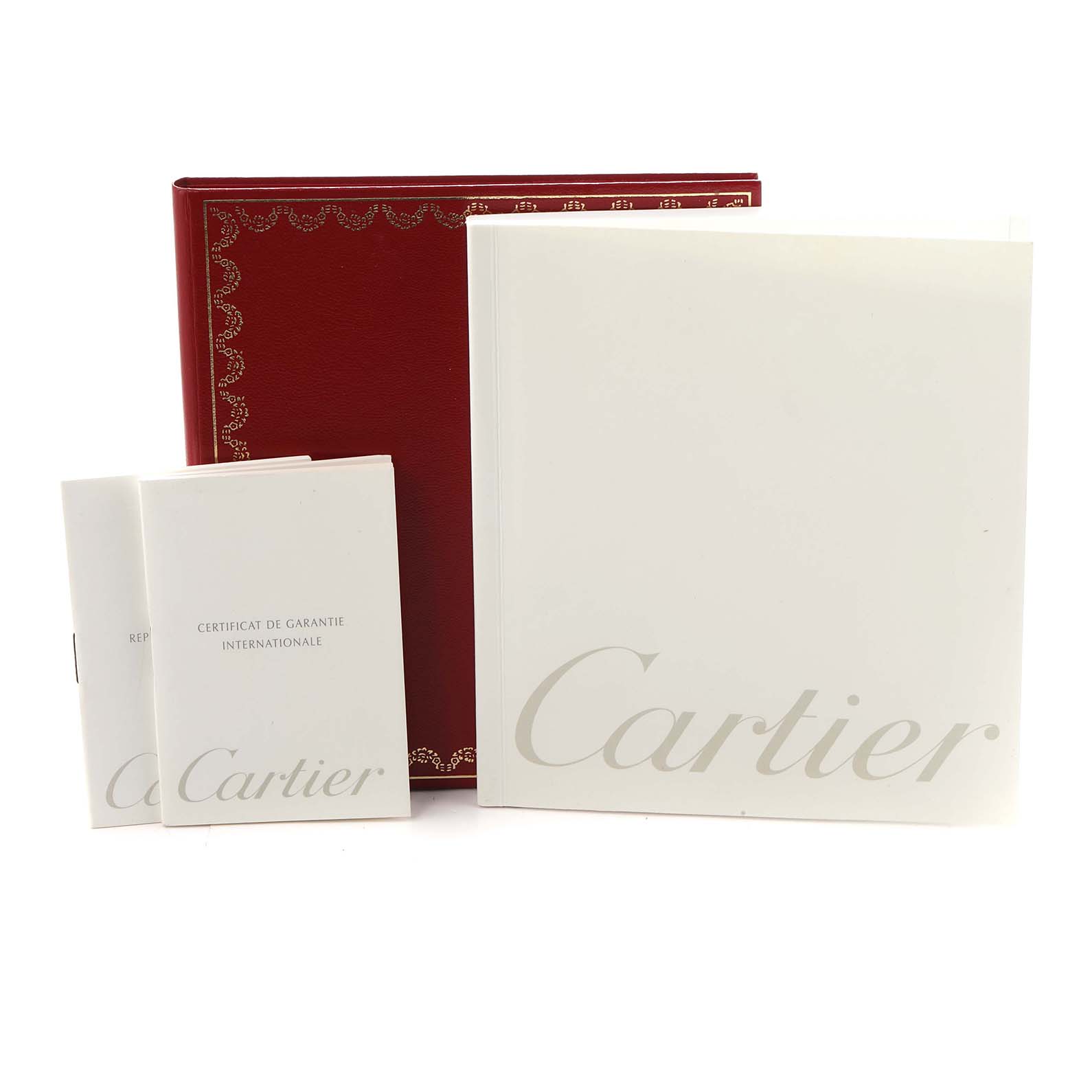 The image shows Cartier Tank Francaise W51008Q3 Women
s Stainless Steel Silver Dial watch accessories including a red box, a booklet, and warranty certificates.