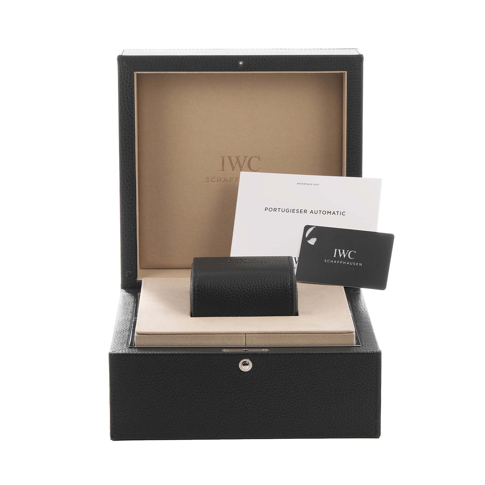 The image shows the packaging for an IWC Portugieser model, including a box with documents and a cushion.