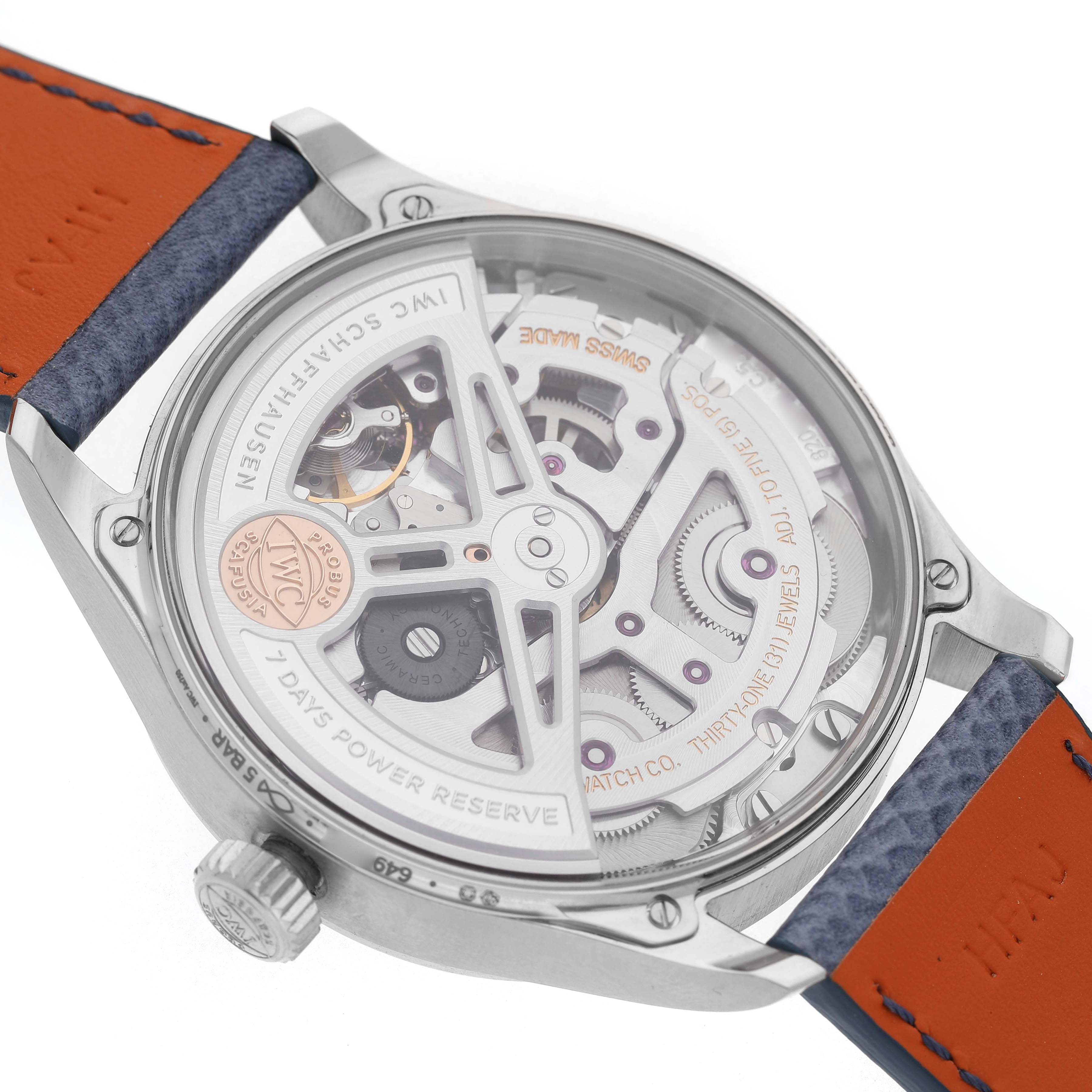 The image shows the back view of an IWC Portuguese IW501708 Men's White Gold Blue Dial watch, highlighting the movement and power reserve mechanism.