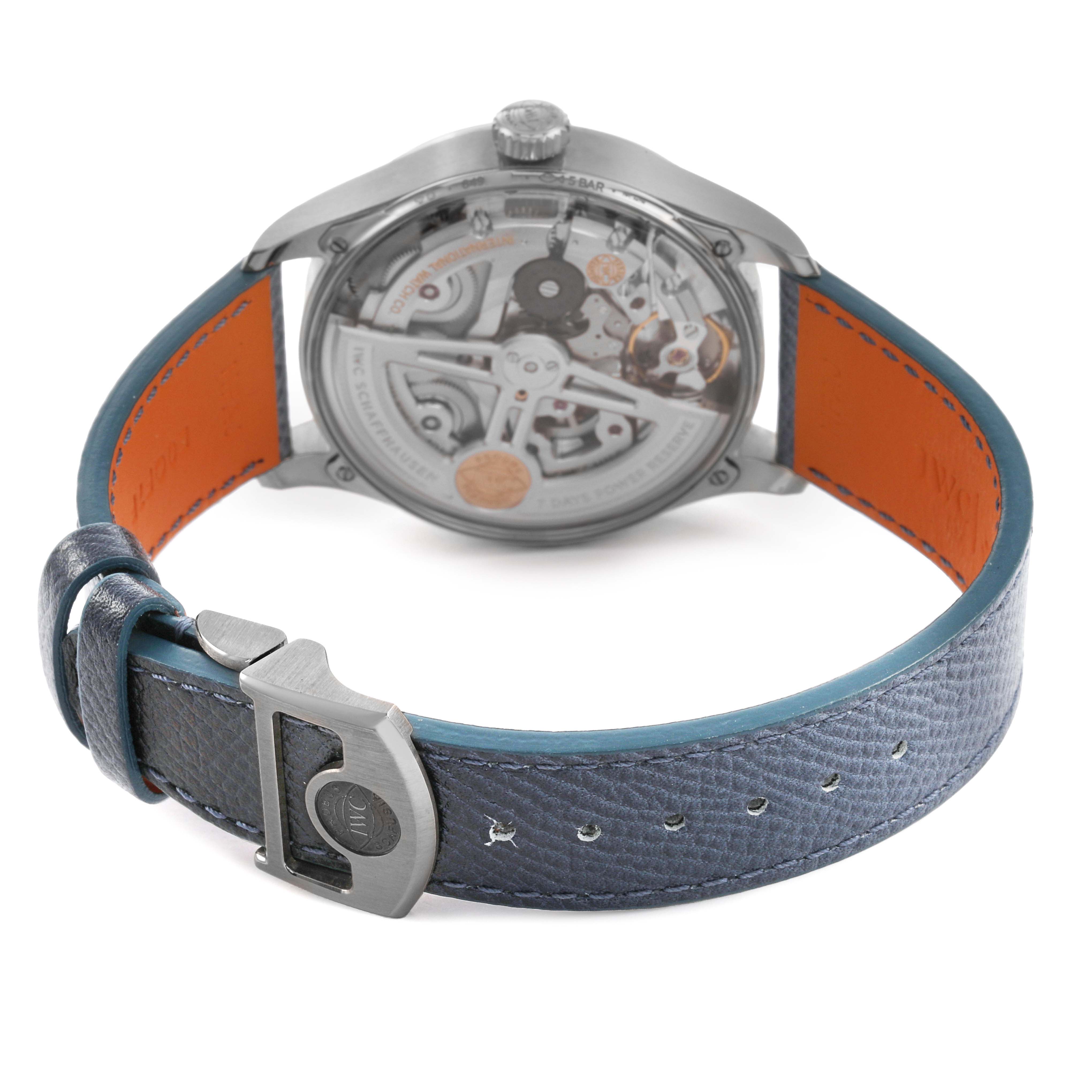 The IWC Portuguese IW501708 Men's White Gold Blue Dial watch is shown from the back, displaying the movement and leather strap with a clasp.