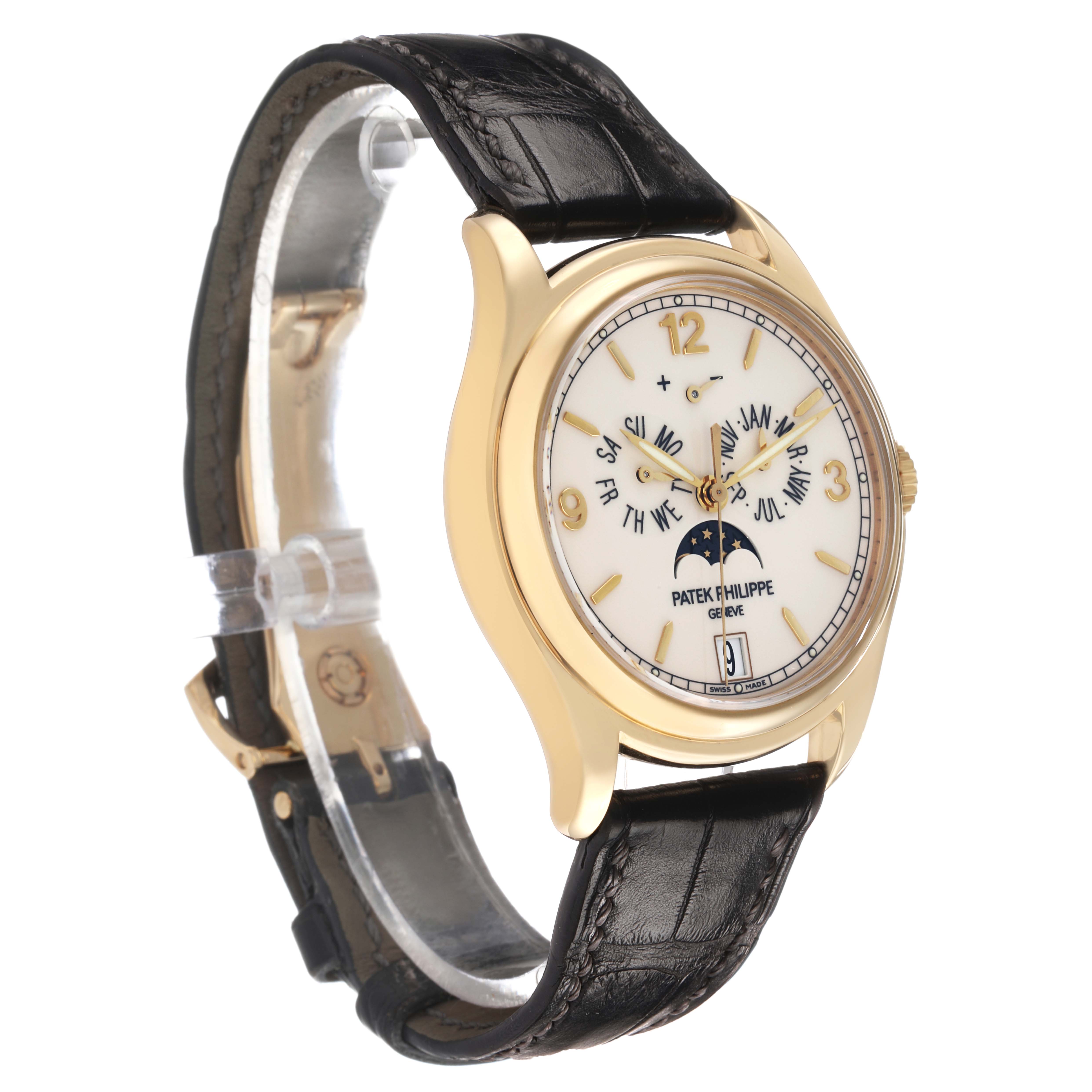 The Patek Philippe Complications 5146J Men's Yellow Gold White Dial watch is shown from a side angle, highlighting its face, gold case, and black leather strap.