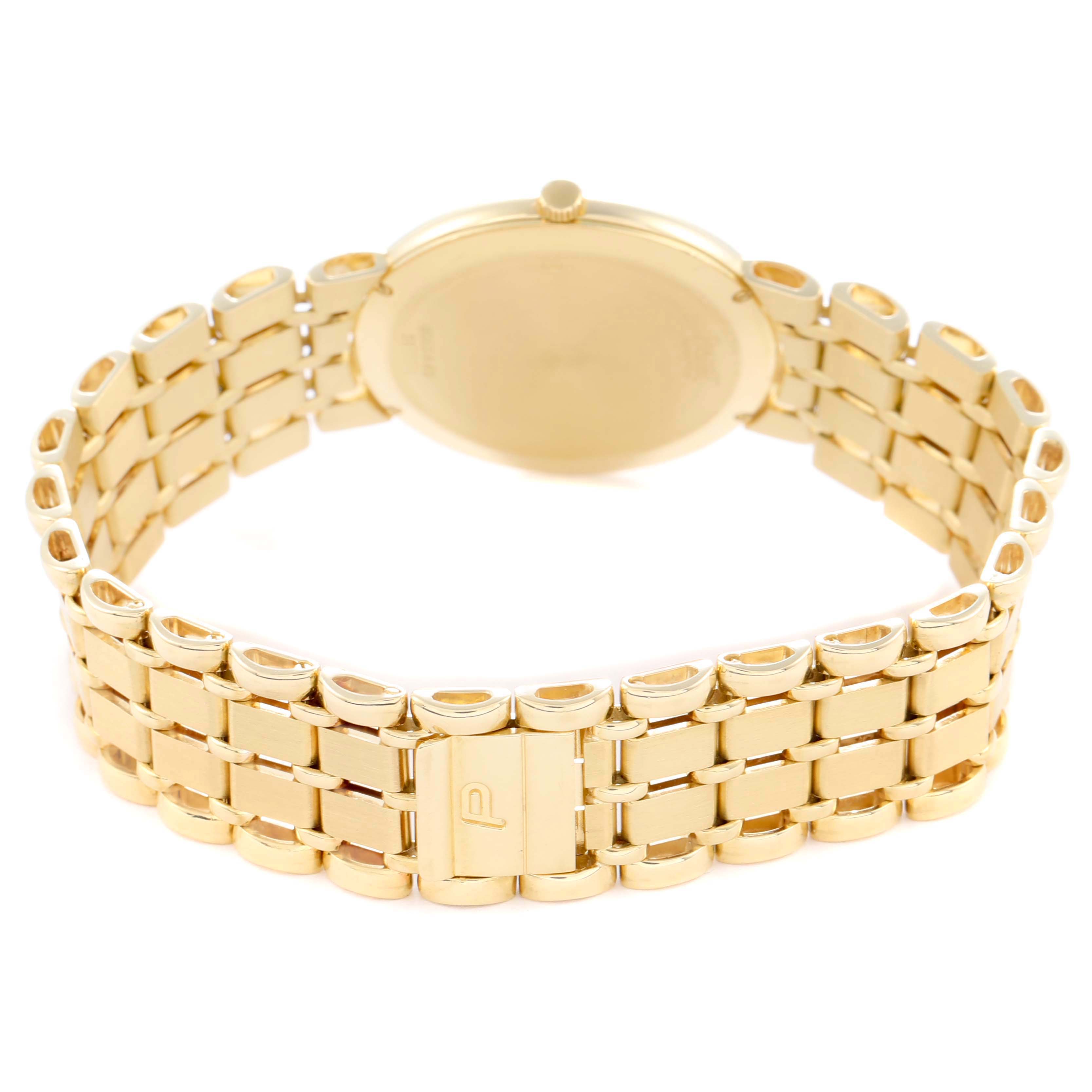 The image shows the backside of the Piaget 8065K43 Women
s Yellow Gold White Dial 8065K43 watch, highlighting the case back and gold bracelet with its clasp.