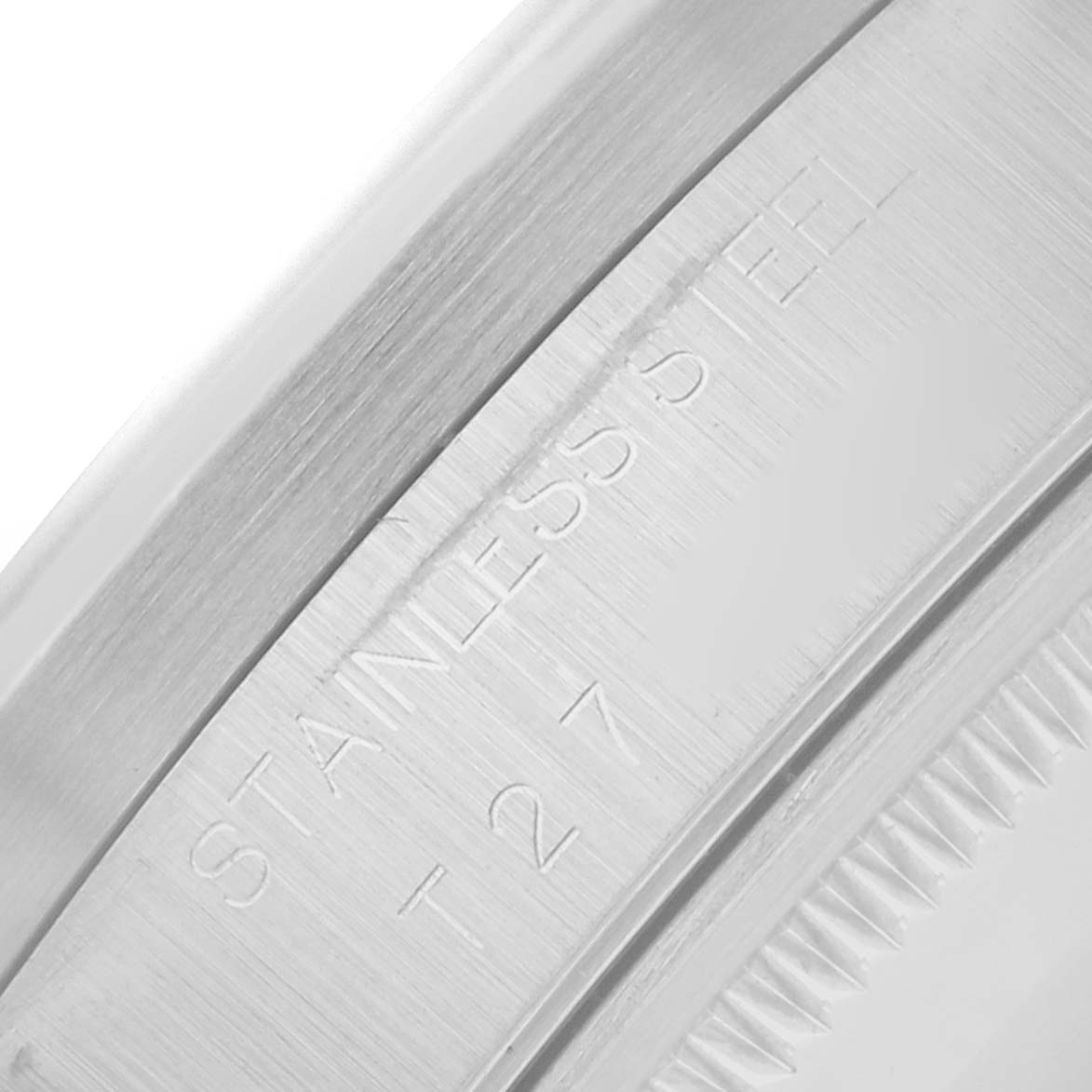 The image shows a close-up of the side of the stainless steel bezel of a Rolex Air-King 14010 Men
s Stainless Steel White Dial watch.