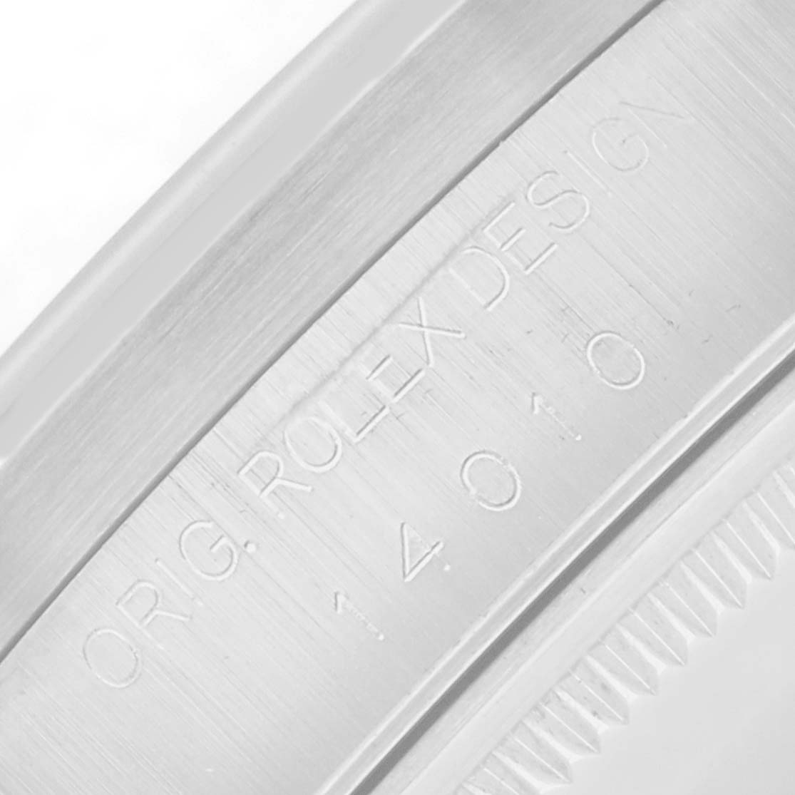 The image shows a close-up of the engraving on the casing of a Rolex Air-King 14010 Men
s Stainless Steel White Dial watch.