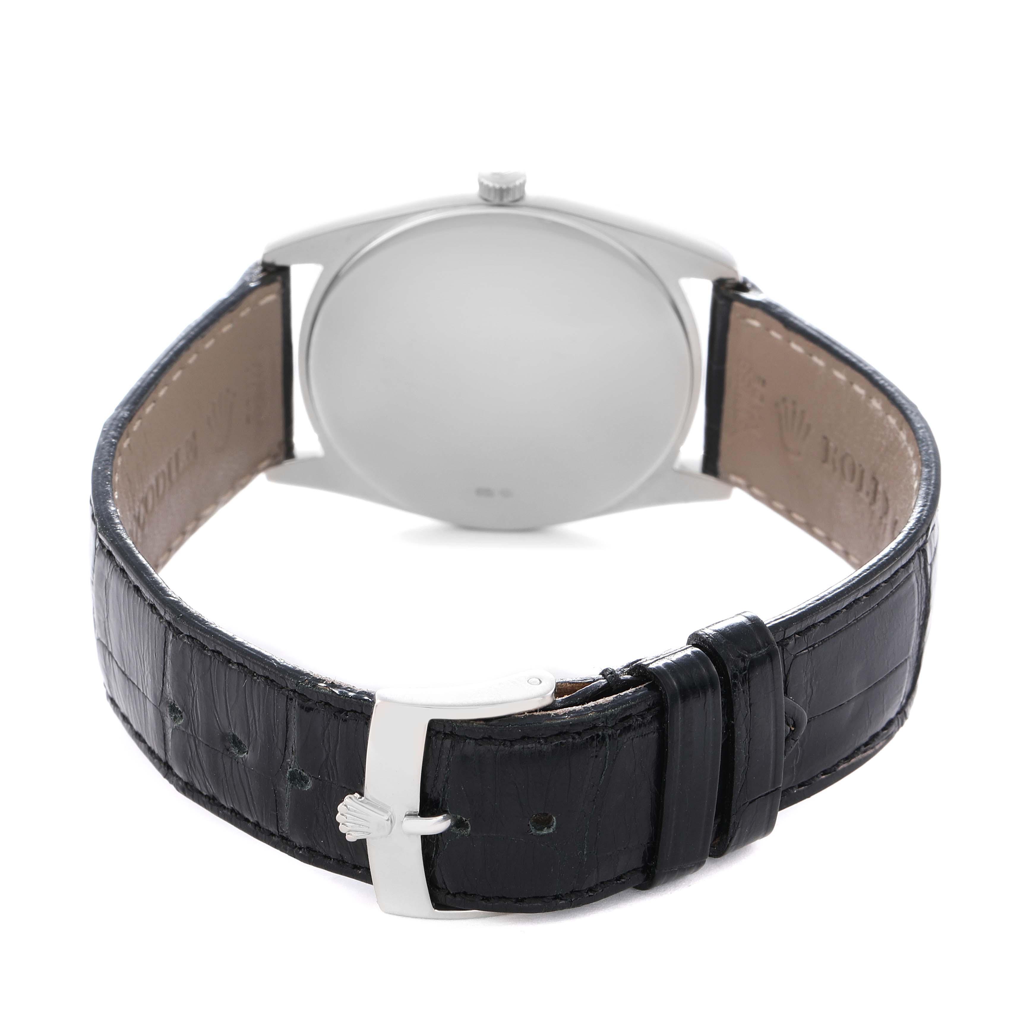 The image shows the back view of a Rolex Cellini 4233 Men
s White Gold White Dial watch, focusing on the leather strap and clasp with a visible crown logo.