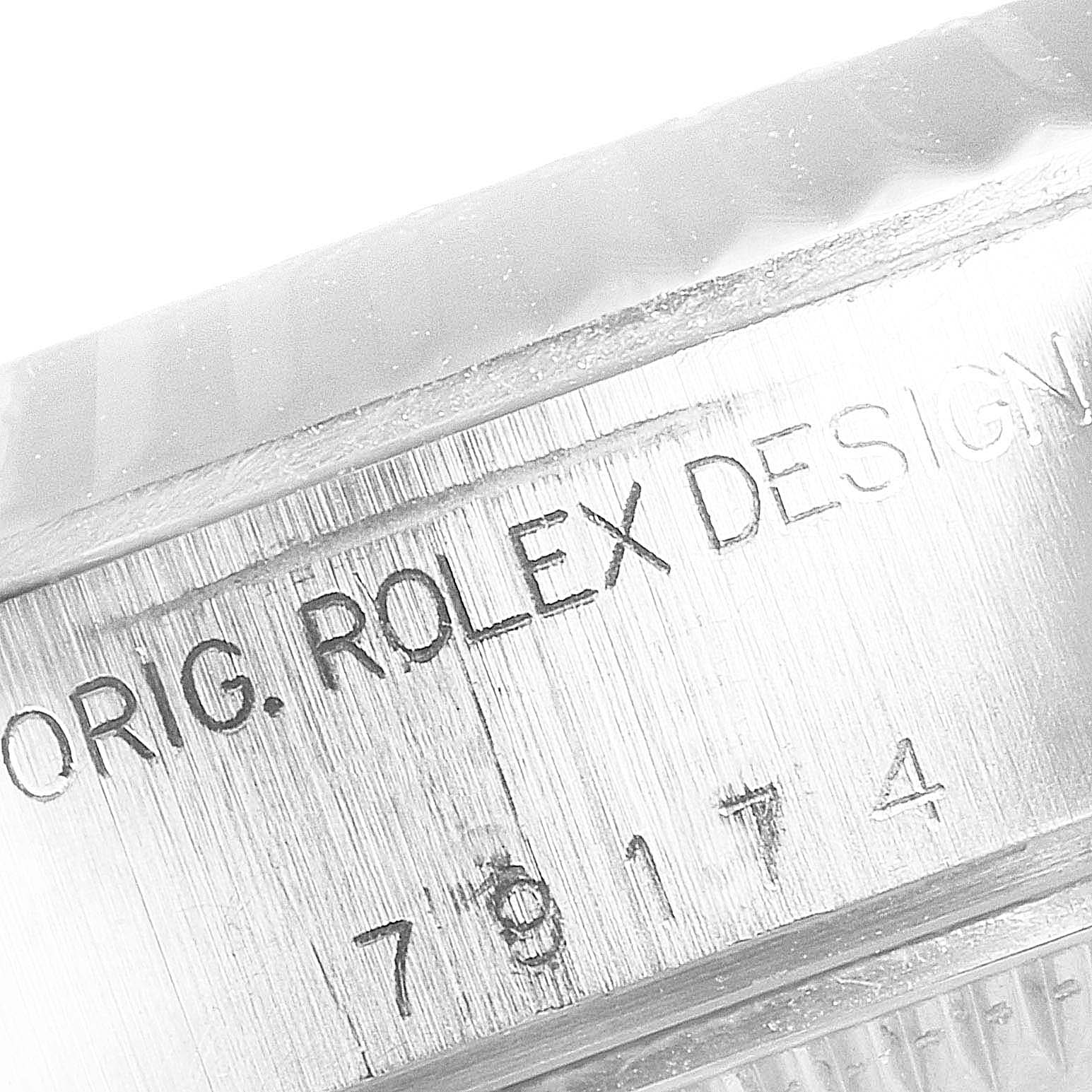 This image shows a close-up of the engraving on the side of a Rolex Datejust 79174 Women's Stainless Steel Black Dial 79174 Women's Stainless Steel Black Dial watch.