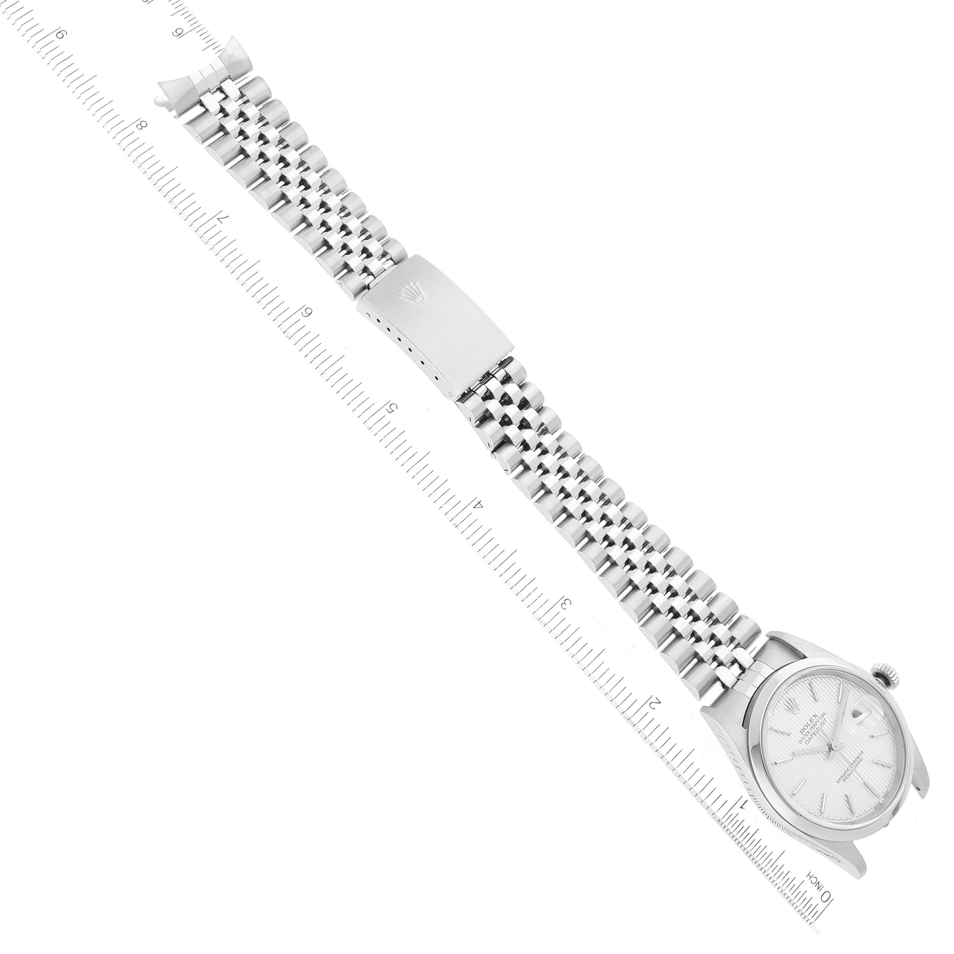 This image shows the Rolex Datejust 16200 Men's Stainless Steel Silver Dial 16200 Men's Stainless Steel Silver Dial watch laid out flat from a top-down angle with an attached ruler for scale.