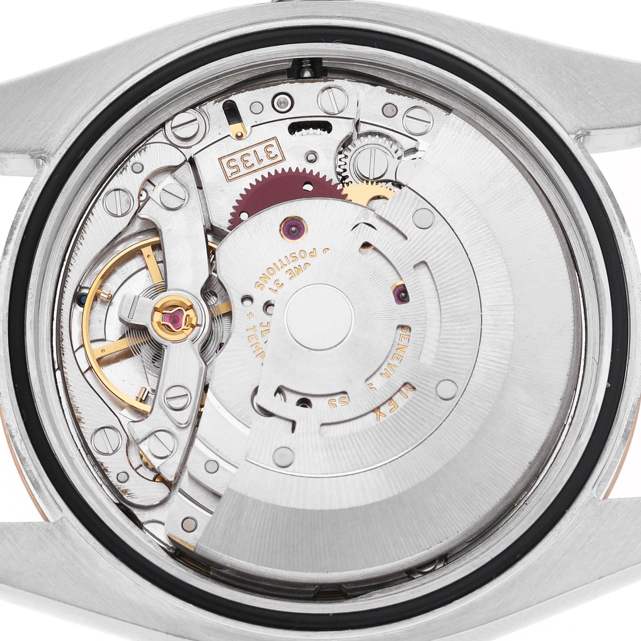 The image shows the Rolex Datejust 116201 Men's Steel and Gold (two tone) White Dial's movement from a top-down angle, featuring gears and the rotor inside the case.