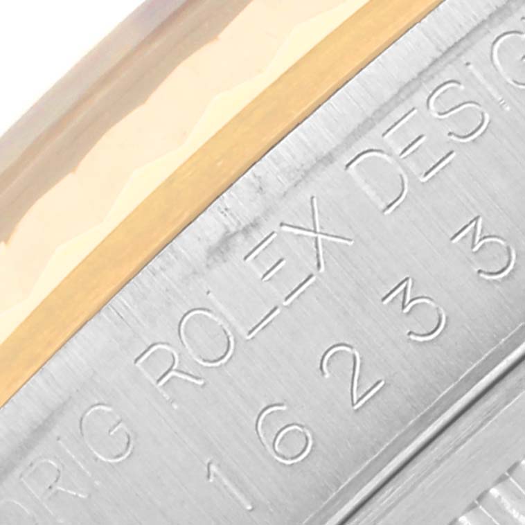 This close-up image shows the engraved model number and “Rolex Design” inscription on the side of a Rolex Datejust 16233 Men's Steel and Gold (two tone) Black Dial 16233 Men's Steel and Gold (two tone) Black Dial watch case.