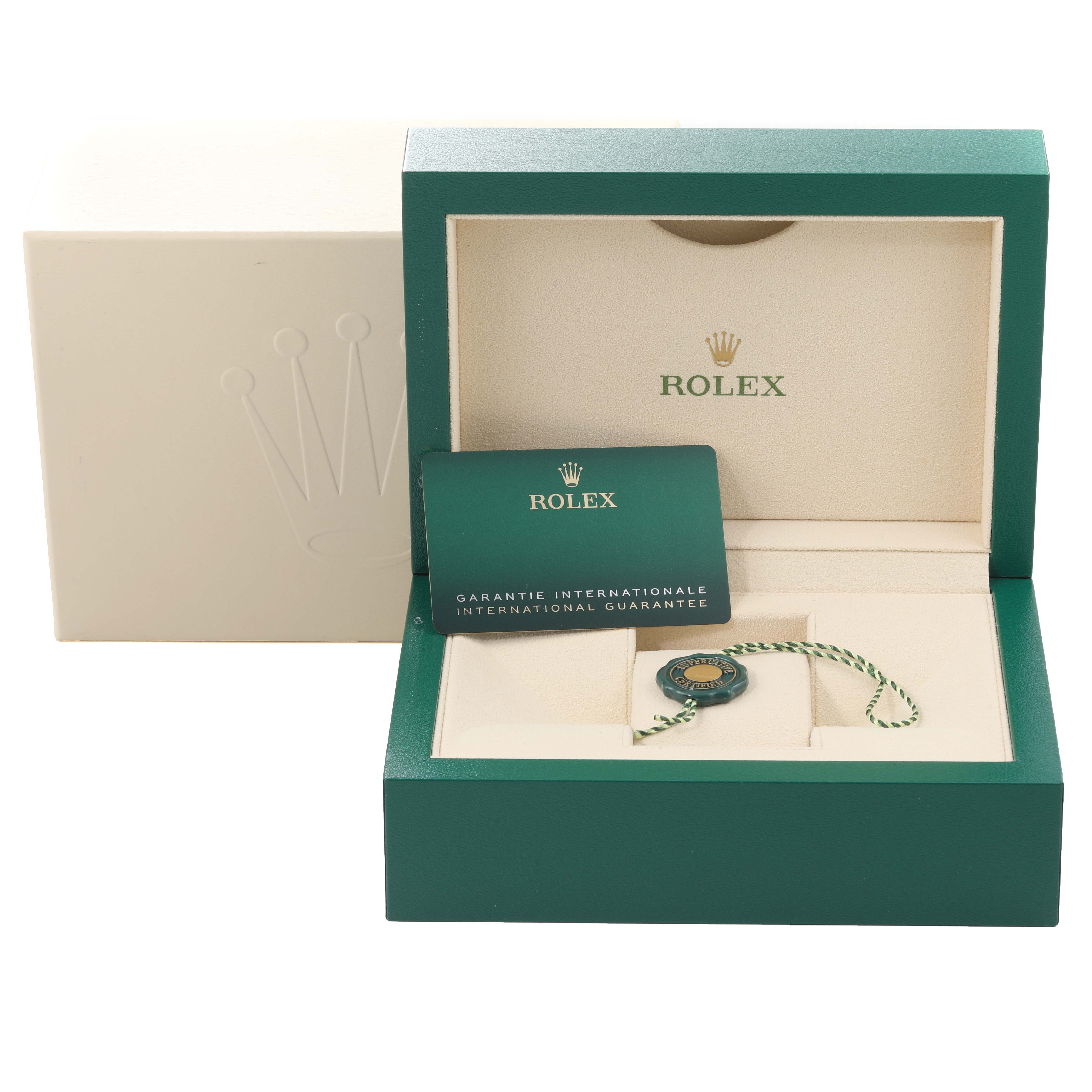 This image shows the accessories and packaging of a Rolex Datejust 41 126303 Men's Steel and Gold (two tone) Champagne Dial 126303 Men's Steel and Gold (two tone) Champagne Dial, including the warranty card, hang tag, and green box.