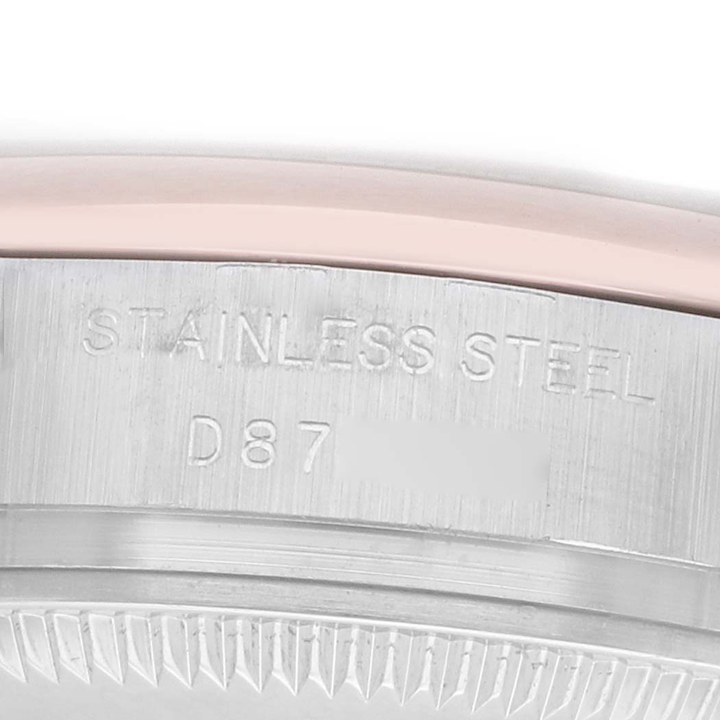 The image shows a close-up of the side of a Rolex Datejust 179161 Women
s Steel and Gold (two tone) Pink Dial watch, highlighting the stainless steel part with engraved markings.