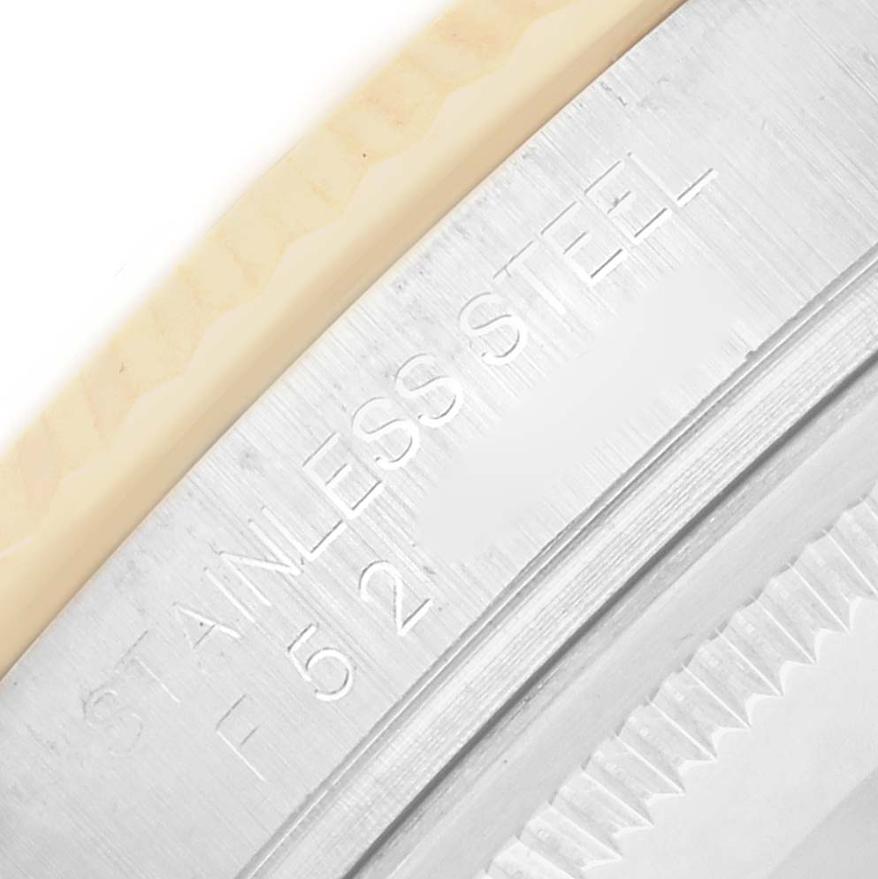 The image shows a close-up of the case back edge of a Rolex Datejust 116233 Men
s Steel and Gold (two tone) Champagne Dial watch, highlighting the "STAINLESS STEEL" engraving.