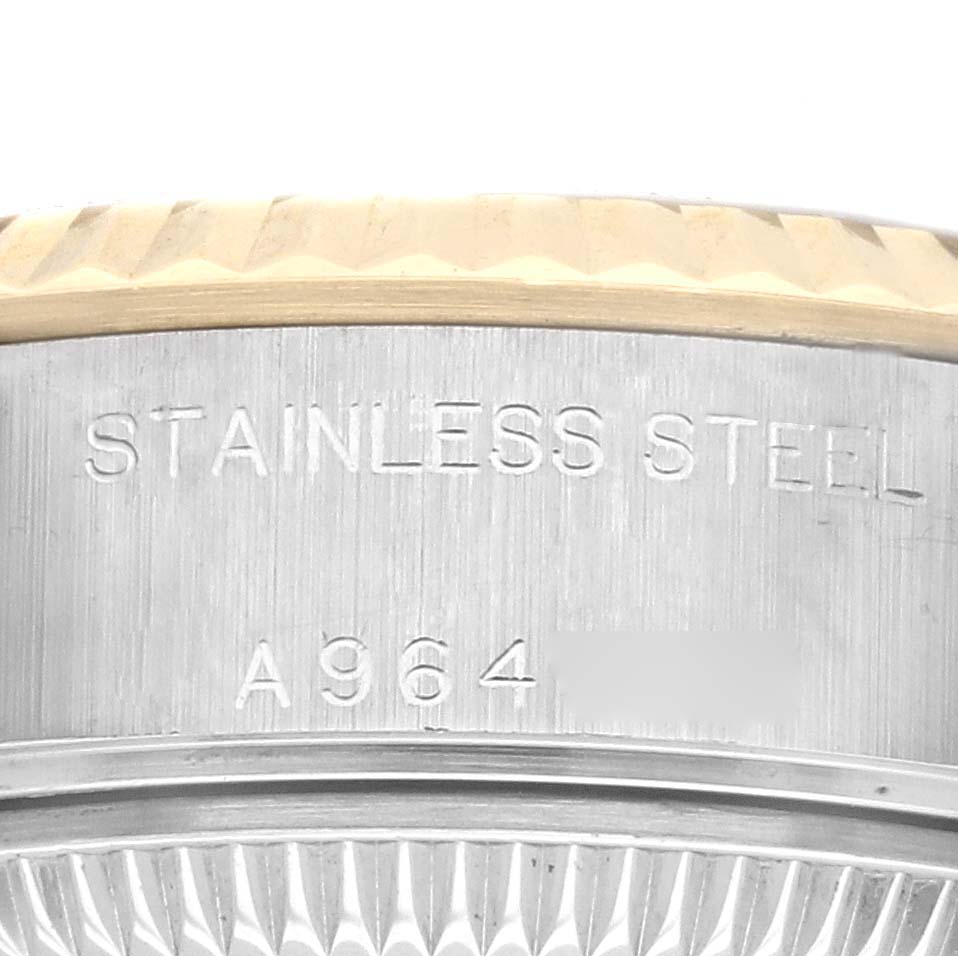 This image shows a close-up of the stainless steel case back engraving and fluted bezel of a Rolex Datejust 79173 Women's Steel and Gold (two tone) Champagne Dial 79173 Women's Steel and Gold (two tone) Champagne Dial watch.