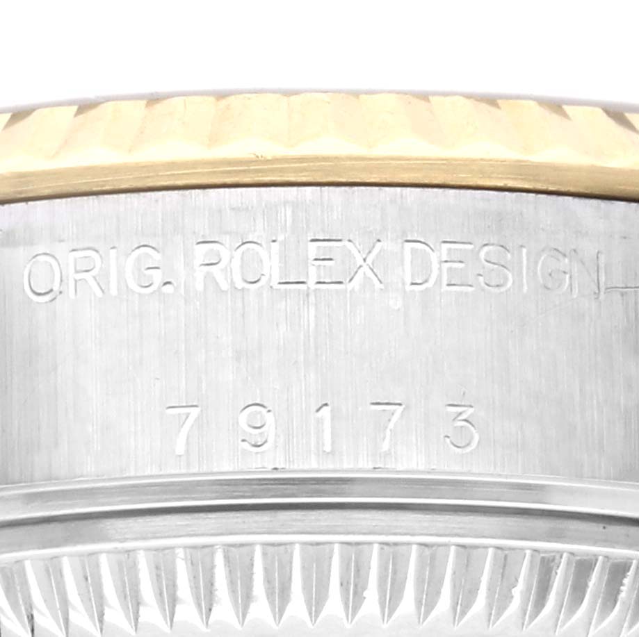 The image shows a close-up of the side of a Rolex Datejust 79173 Women's Steel and Gold (two tone) Champagne Dial 79173 Women's Steel and Gold (two tone) Champagne Dial watch with the model number 79173 engraved.