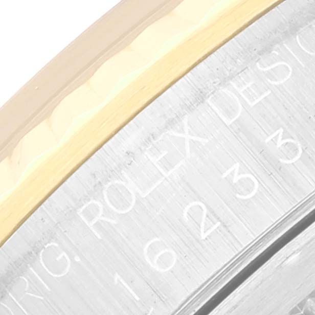 The image shows a close-up angle of the Rolex Datejust 16233 Men's Steel and Gold (two tone) Grey Dial 16233 Men's Steel and Gold (two tone) Grey Dial model's watch bezel and engraved design text.
