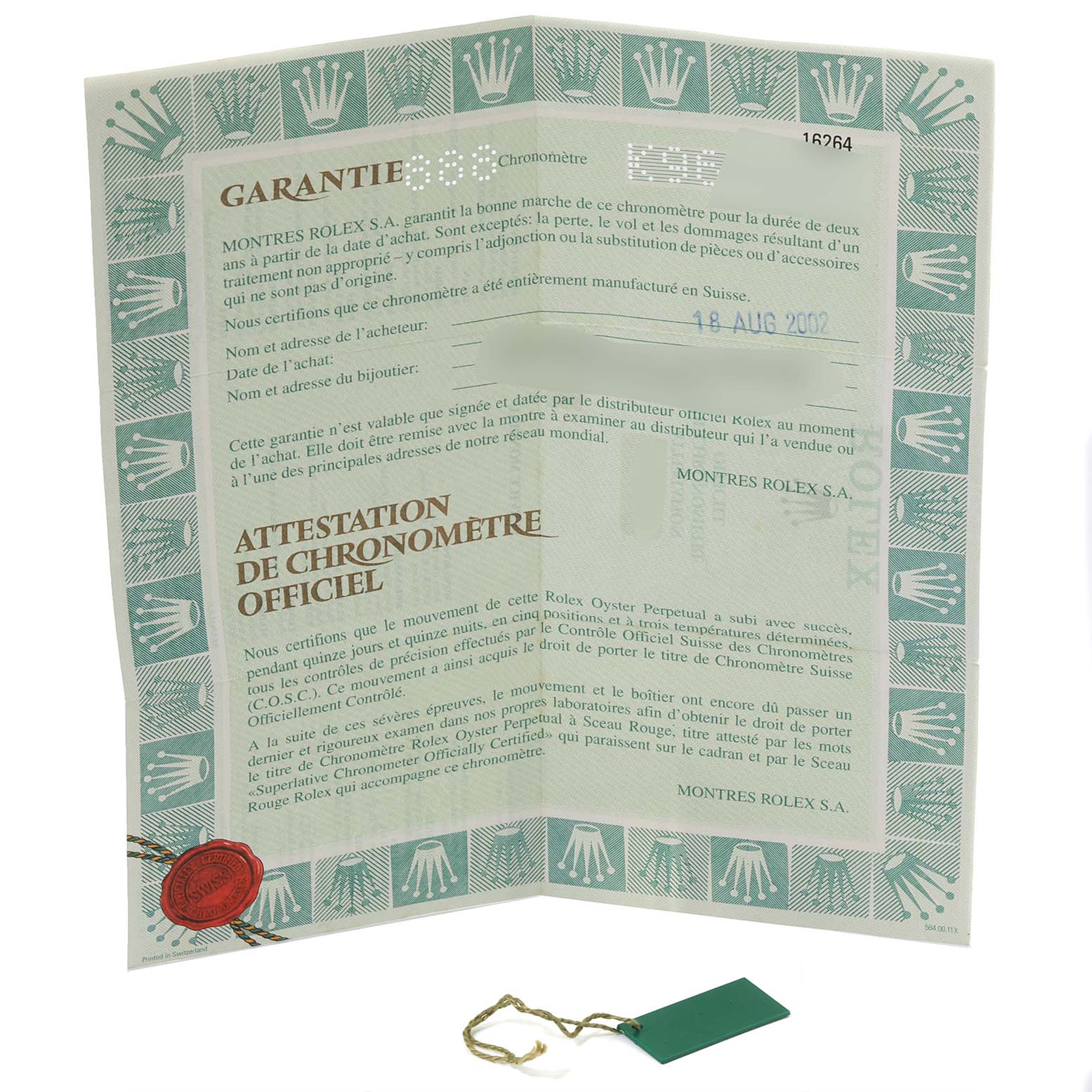 This image shows the warranty document and a green tag accessory for the Rolex Turn-o-Graph 16264 Men's Stainless Steel Black Dial 16264 Men's Stainless Steel Black Dial watch.