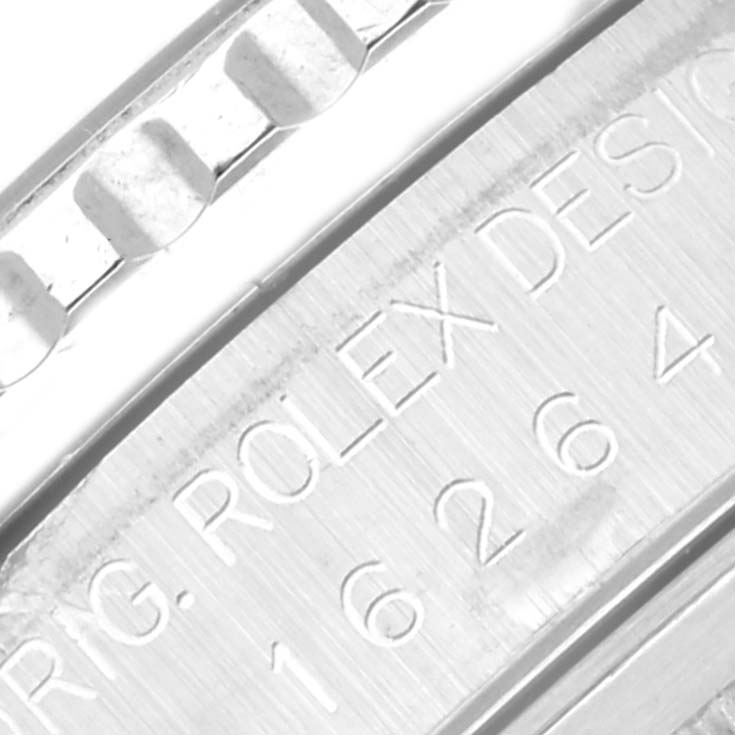 The image shows a close-up shot of the engraved text and part of the bezel of a Rolex Turn-o-Graph 16264 Men's Stainless Steel Black Dial 16264 Men's Stainless Steel Black Dial model watch.