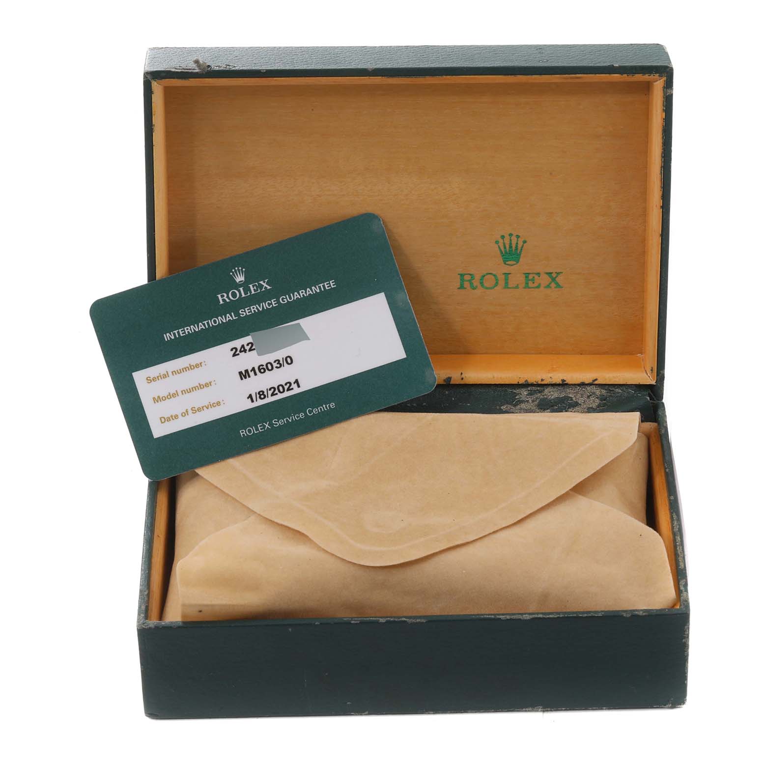 The image shows a green Rolex box with an International Service Guarantee card and a wrapped item inside, part of the Vintage Collection model.