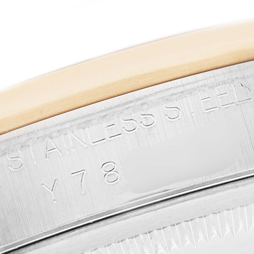 The image shows the edge of the case back of a Rolex Datejust 16203 Men
s Steel and Gold (two tone) Mother of Pearl Dial, highlighting the stainless steel with engraved text.