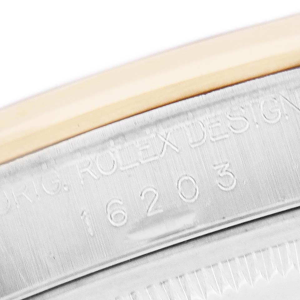 The image shows a close-up of the engraved casing of a Rolex Datejust 16203 Men
s Steel and Gold (two tone) Mother of Pearl Dial, highlighting the model number "16203."
