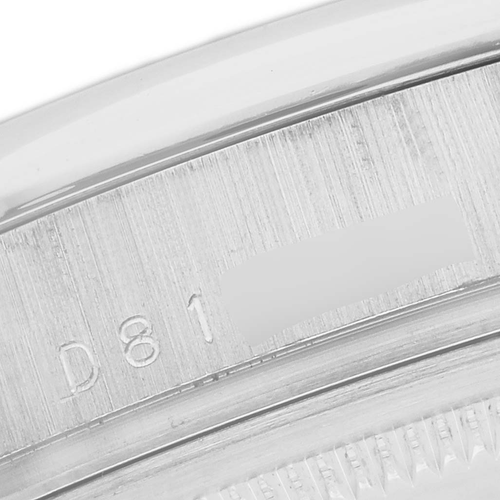 This close-up image shows the engraved serial number on the case edge of a Rolex President 118206 Men's Platinum Blue Dial 118206 Men's Platinum Blue Dial model watch.