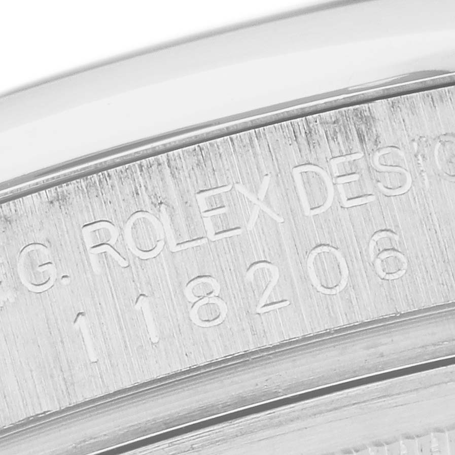 The close-up image shows the serial and model number engravings on the side of the case of a Rolex President 118206 Men's Platinum Blue Dial 118206 Men's Platinum Blue Dial watch.