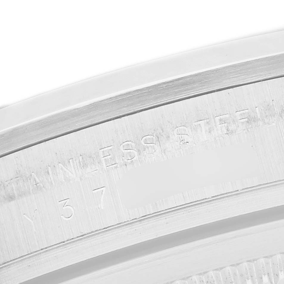 The image shows a close-up of the rim of a Rolex Explorer 114270 Men
s Stainless Steel Black Dial watch, focusing on the engraved text on the stainless steel.