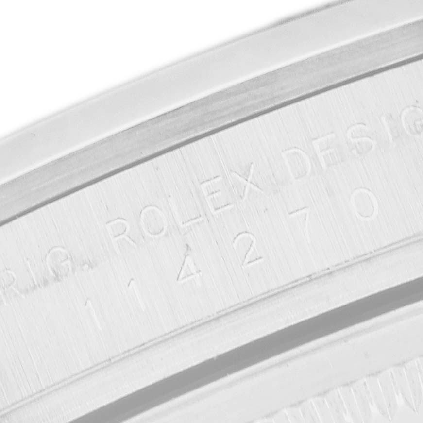 The image shows a close-up of the bezel side of the Rolex Explorer 114270 Men
s Stainless Steel Black Dial, highlighting engraved details.