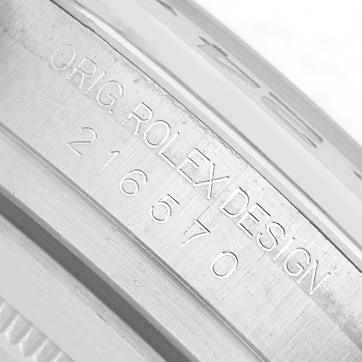 The image shows the engraved inner bezel of a Rolex Explorer 216570 Men
s Stainless Steel Black Dial, featuring the model number 216570.