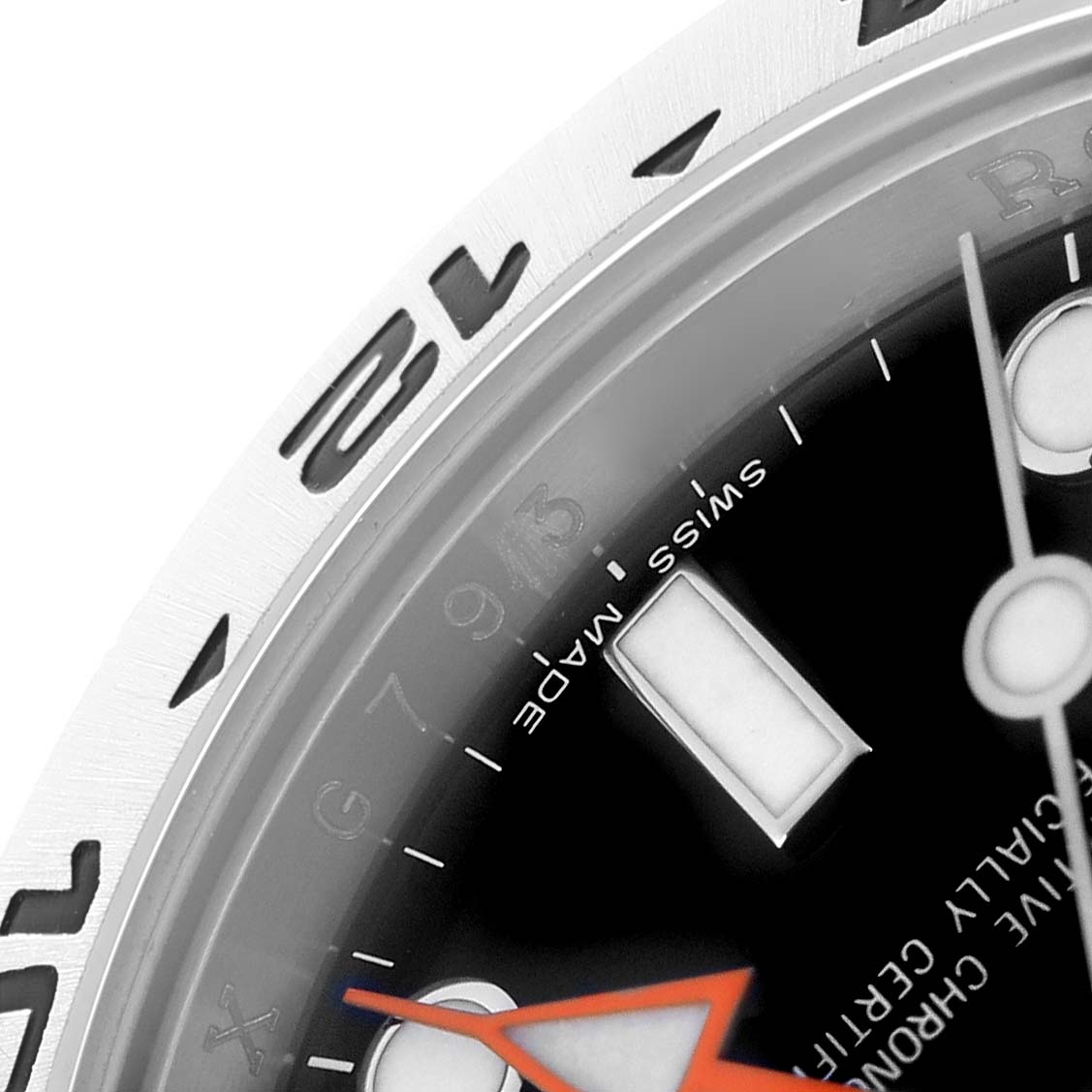 The image shows a close-up of the Rolex Explorer 216570 Men
s Stainless Steel Black Dial watch
s bezel and dial, featuring partial hour markers and hands.
