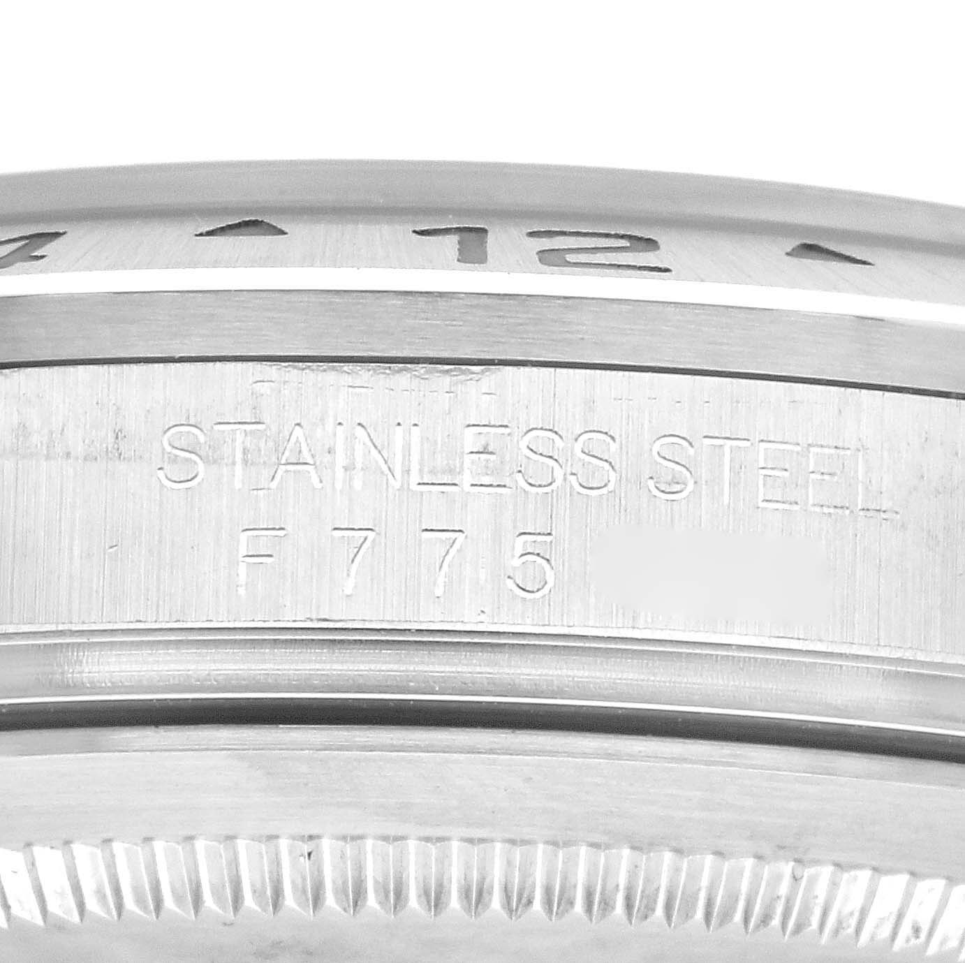 The image shows a close-up view of the stainless steel case side of the Rolex Explorer 16570 Men
s Stainless Steel Black Dial 16570 Men
s Stainless Steel Black Dial watch, focusing on the engraved text.