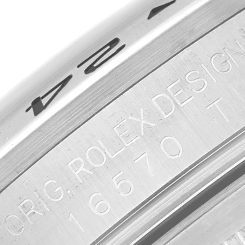 The image shows a close-up of the engraved case side of a Rolex Explorer 16570 Men
s Stainless Steel White Dial 16570 Men
s Stainless Steel White Dial watch, including the model number 16570.