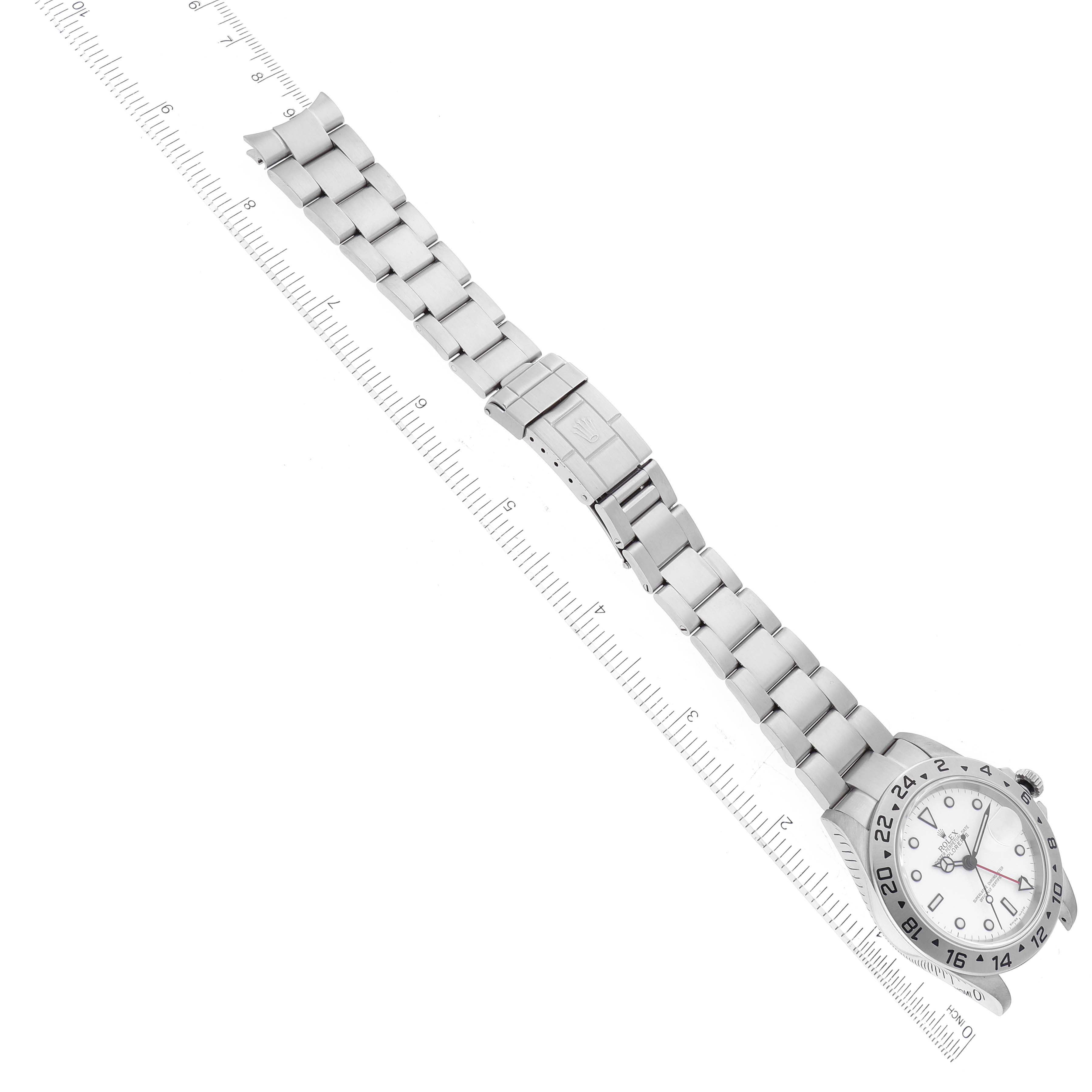 The image shows a laid-flat Rolex Explorer 16570 Men
s Stainless Steel White Dial 16570 Men
s Stainless Steel White Dial watch, highlighting the band and clasp, with a ruler for scale.