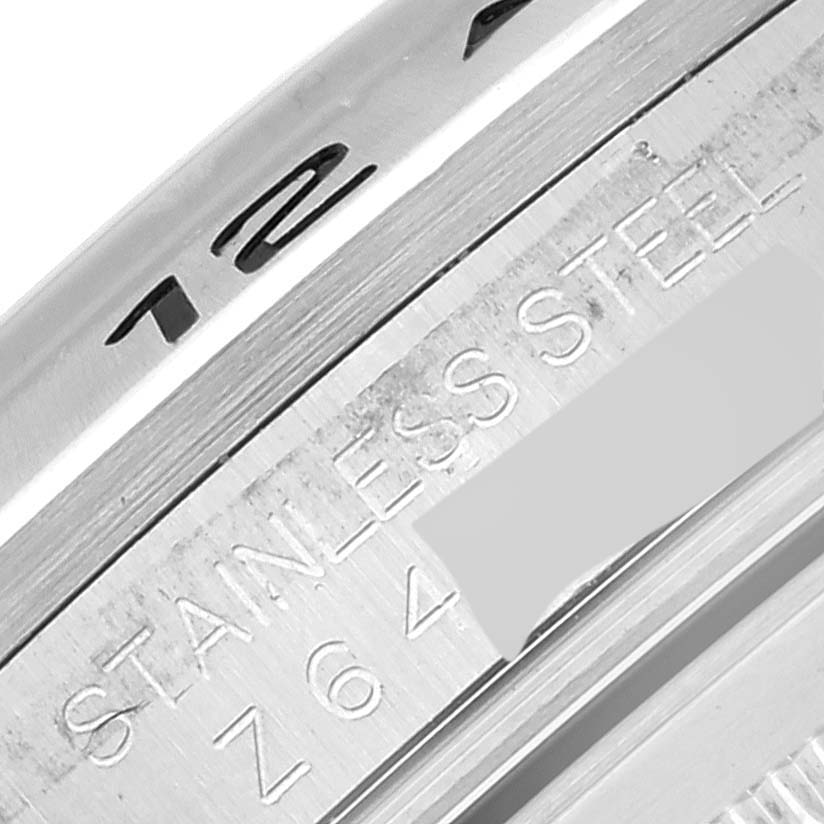 This close-up image shows part of the bezel and engraved inner ring of a Rolex Explorer 16570 Men
s Stainless Steel White Dial 16570 Men
s Stainless Steel White Dial stainless steel watch.