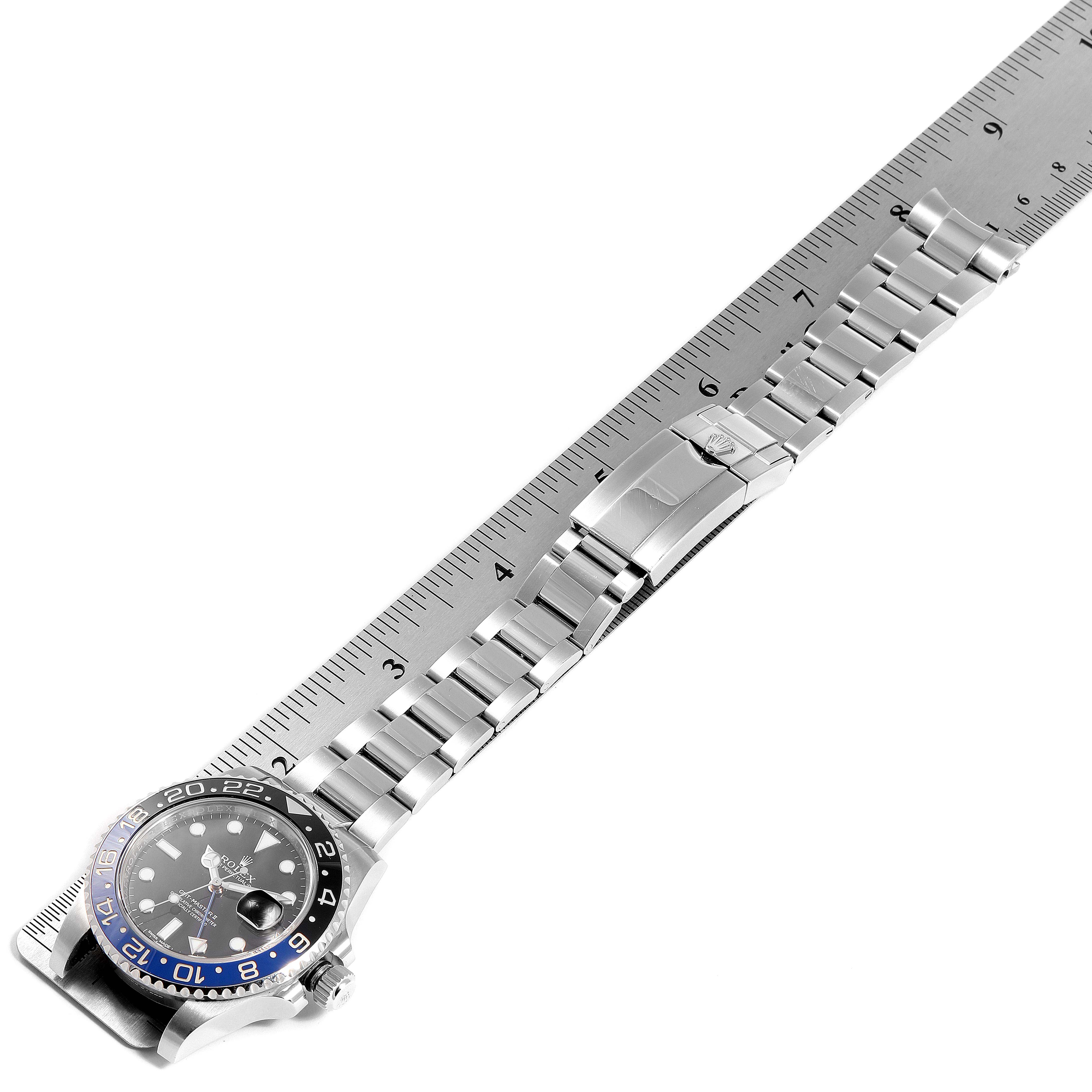 This image shows a side view of the Rolex GMT-Master 116710 Men's Stainless Steel Black Dial 116710 Men's Stainless Steel Black Dial watch, including the bezel, dial, bracelet, and clasp, with a ruler for scale.