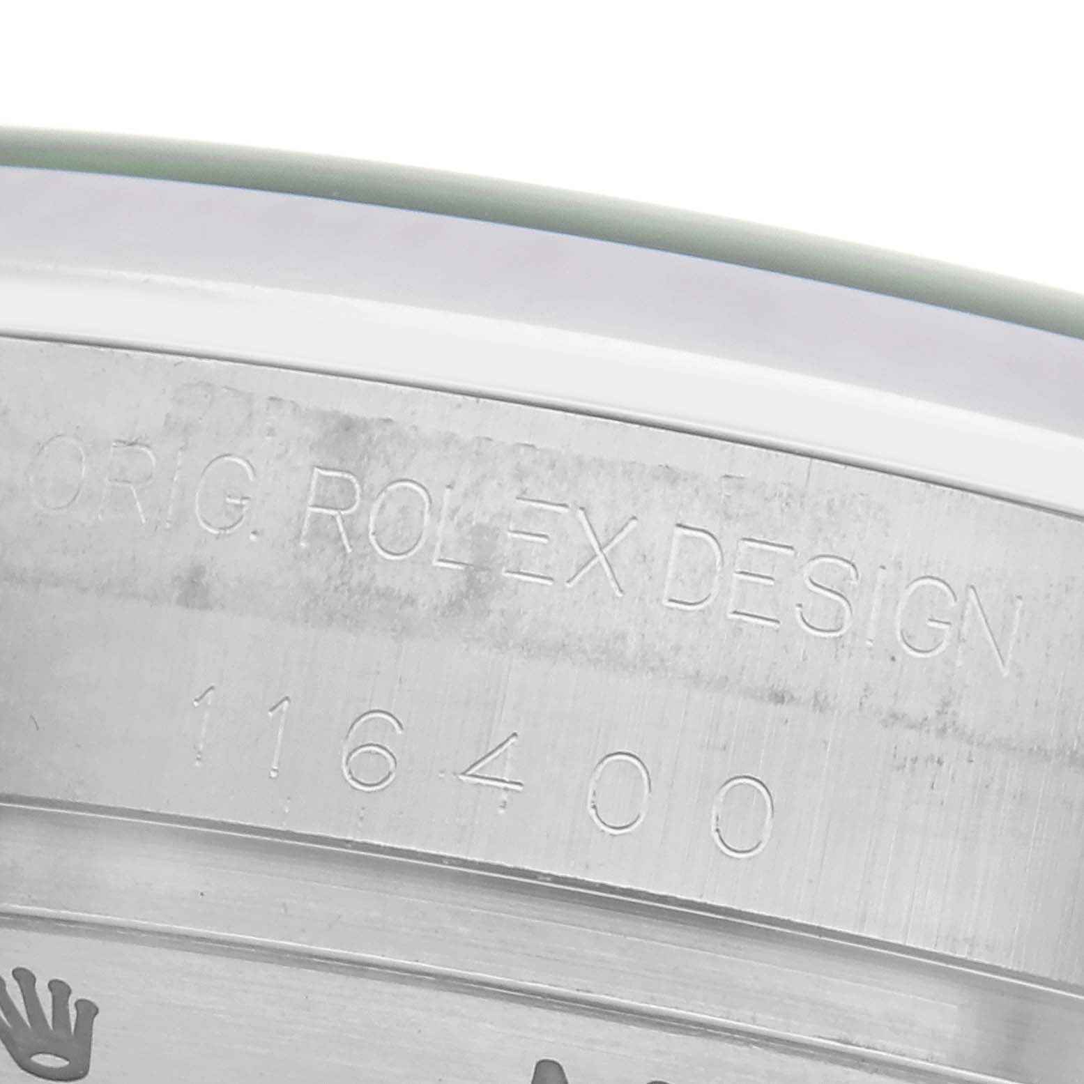 The image shows the side engraving of a Rolex Milgauss 116400GV Men
s Stainless Steel Black Dial watch, highlighting its model number and "ORIG. ROLEX DESIGN" text.
