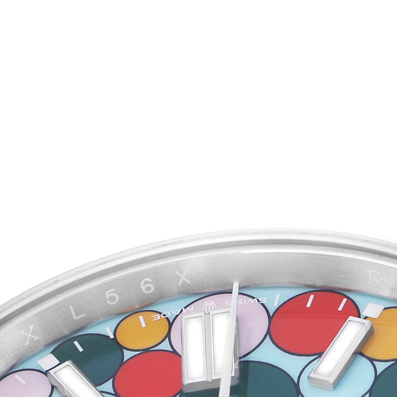 This image shows a close-up of the dial and bezel edge of a Rolex Oyster Perpetual 124300 Men
s Stainless Steel Blue Dial, highlighting its colorful design and markers.