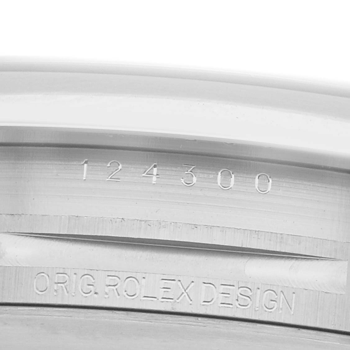 The image shows a close-up of the side of a Rolex Oyster Perpetual 124300 Men
s Stainless Steel Blue Dial watch, highlighting the serial number and original design engraving.