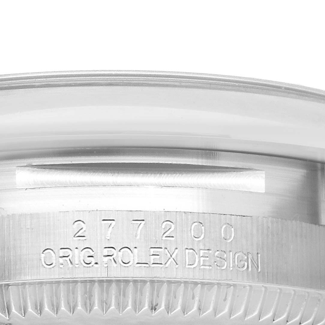 This close-up image shows the engraved model number and "ORIG. ROLEX DESIGN" on the case of a Rolex Oyster Perpetual watch.