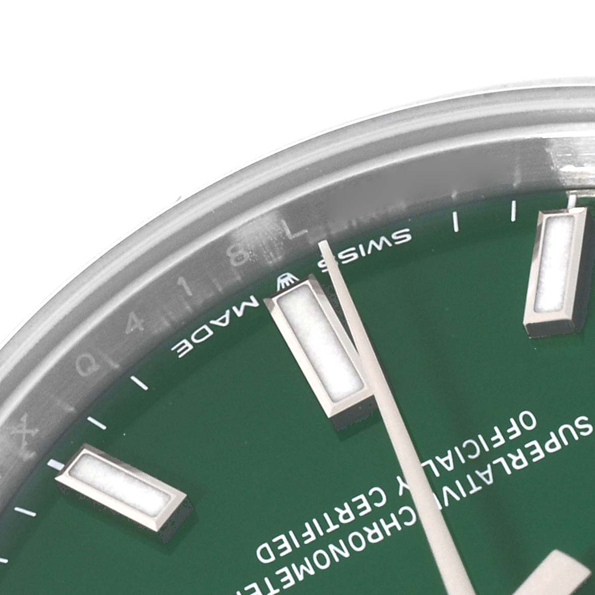 This close-up image shows part of the dial and markers of an Oyster Perpetual model by Rolex.