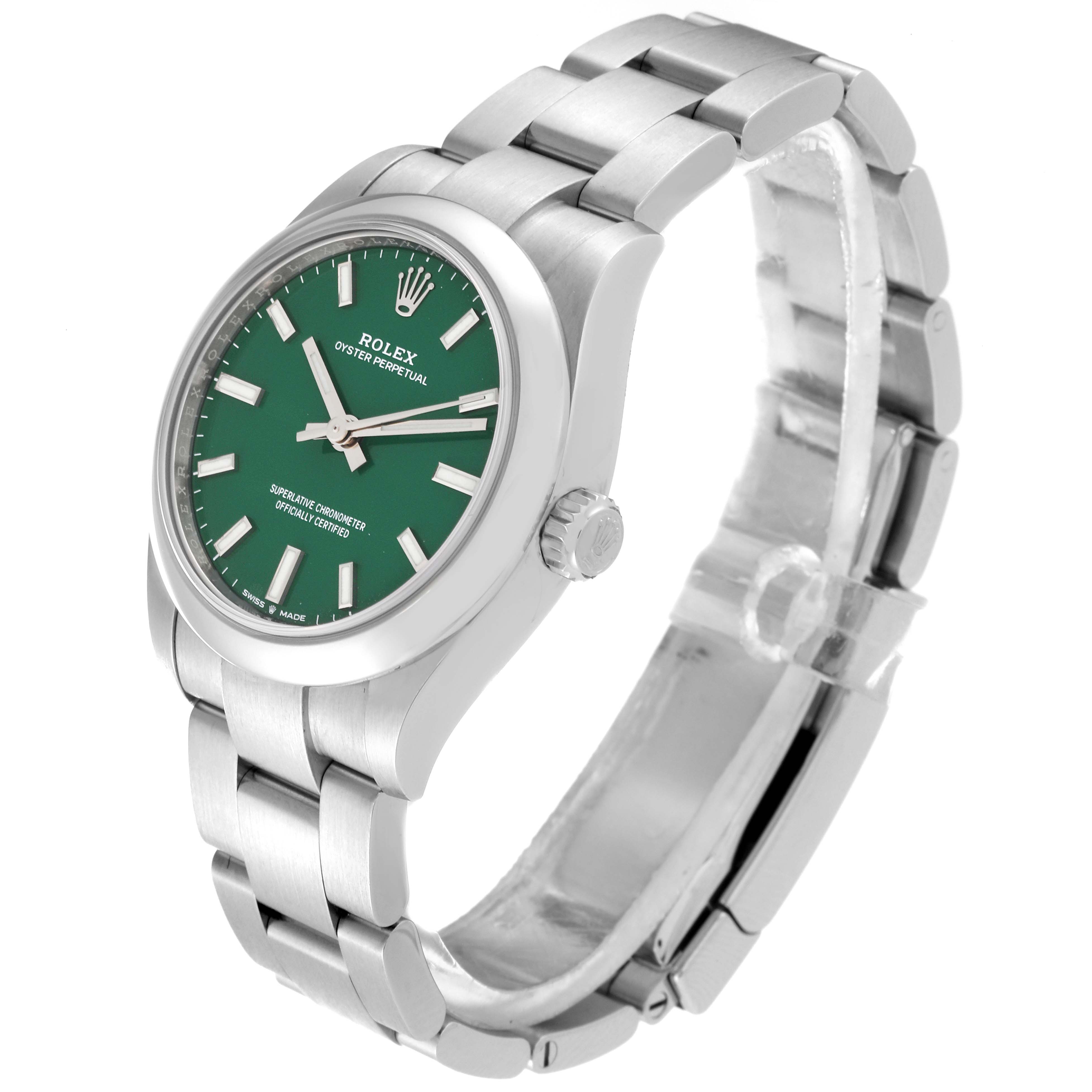 The Rolex Oyster Perpetual watch is shown at a slight angle, displaying the green dial, bracelet, crown, and clasp.