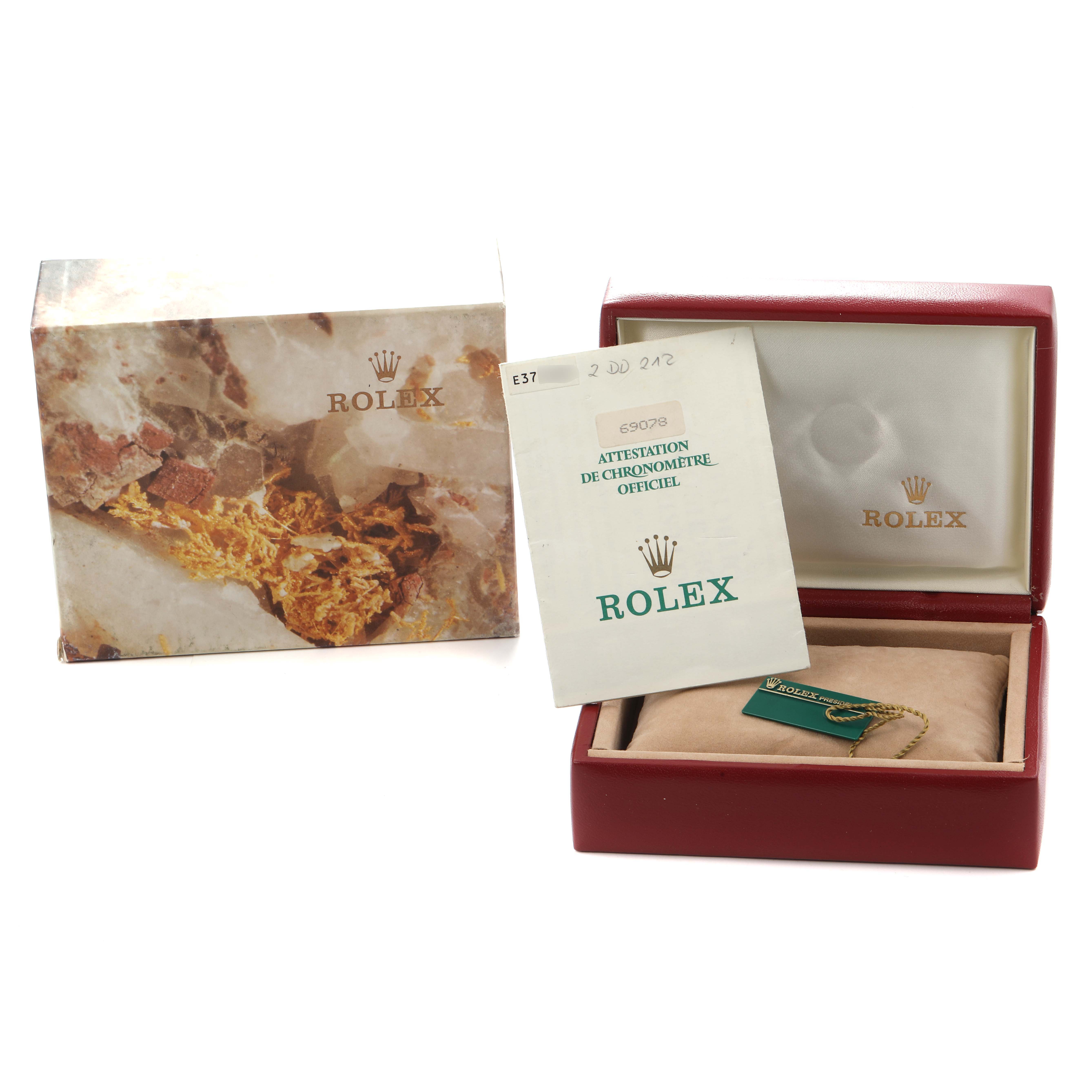 The image shows a Rolex President 69078 Women
s Yellow Gold Champagne Dial model box, paperwork, and tag from a top perspective.